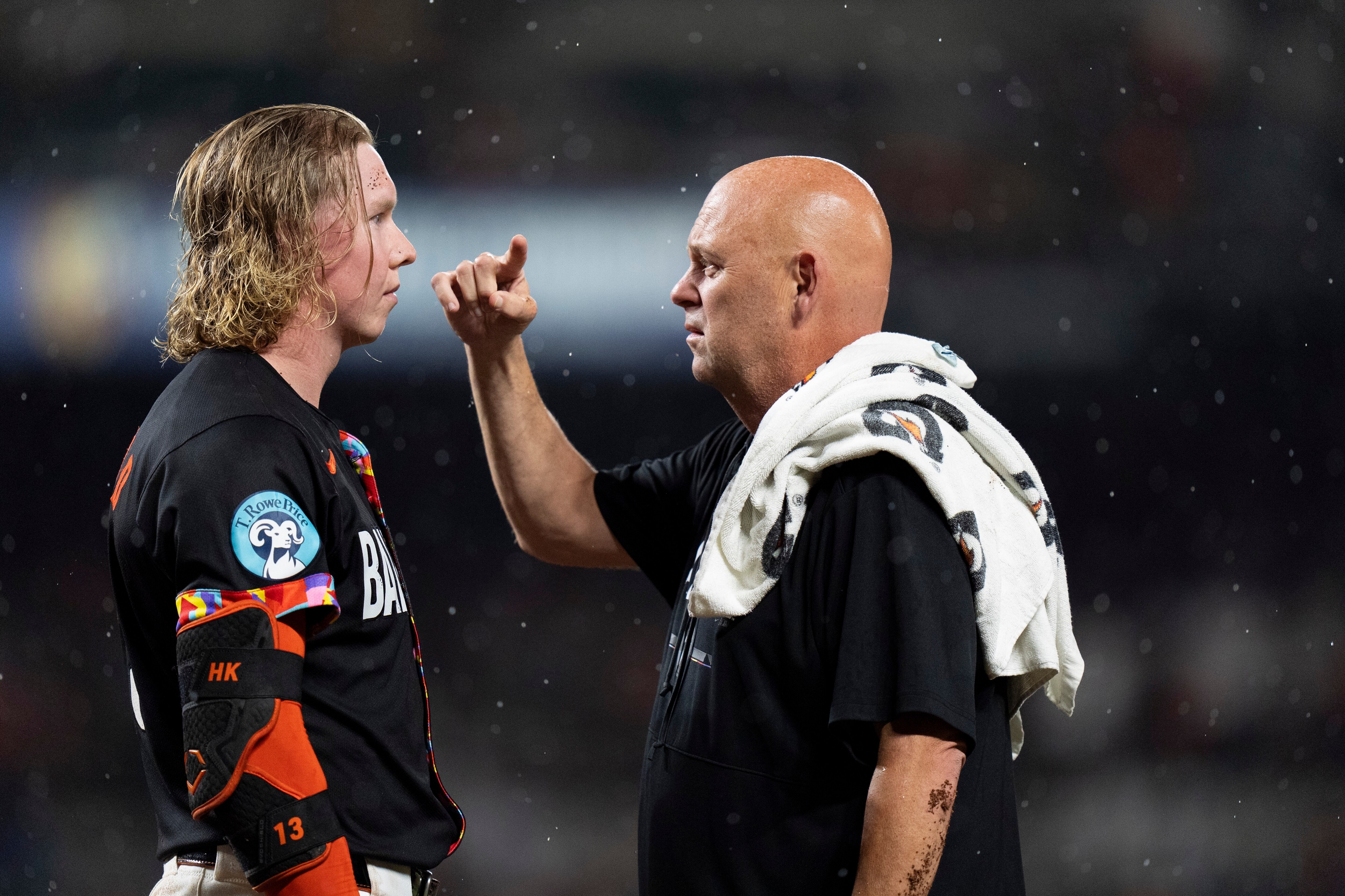 Baltimore Orioles' Heston Kjerstad, left, is evaluated by a trainer, right, after being hit by a pitch from New York Yankees reliever Clay Holmes during the ninth inning of a baseball game, Friday, July 12, 2024, in Baltimore.