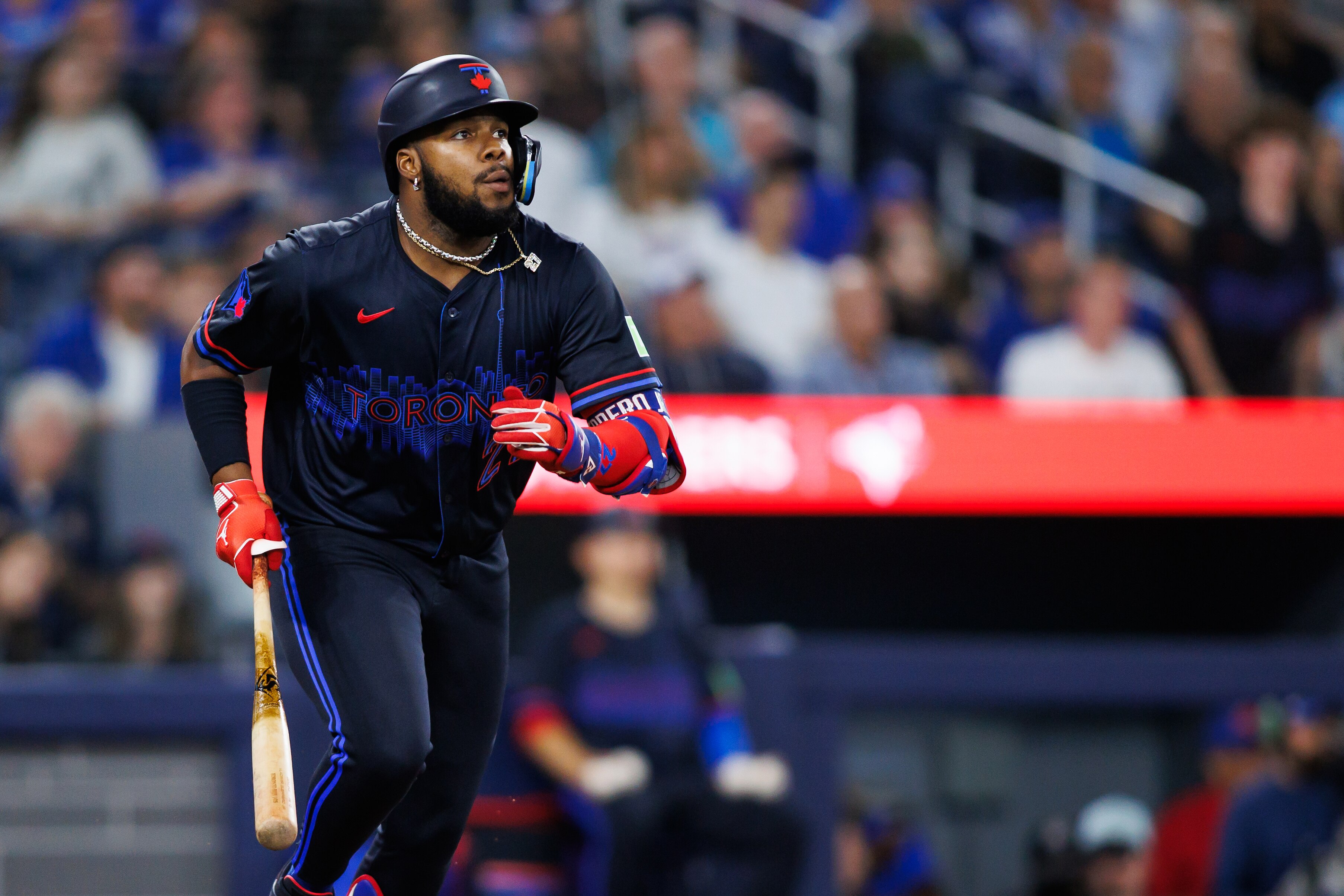 Vladimir Guerrero Jr. watches the ball as he hits a triple in the sixth inning.