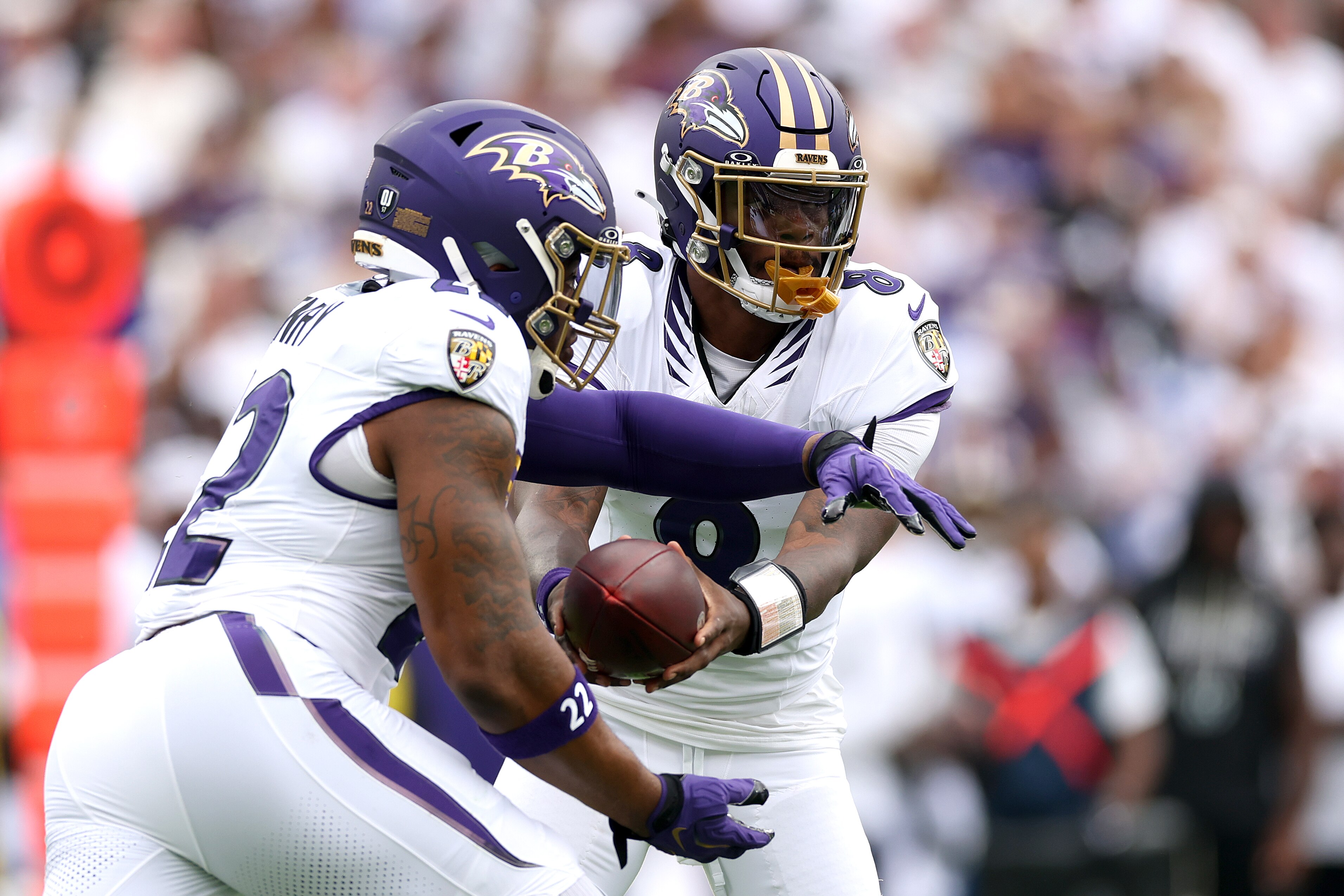 Ravens quaterback Lamar Jackson hands off to running back Derrick Henry against the Saints on Sunday.