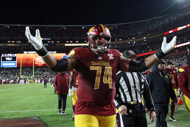 Washington Commanders offensive lineman Brandon Coleman celebrates during halftime of the team's Week 16 game against the Philadelphia Eagles.