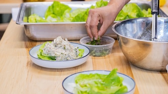 WEDNESDAY, AUGUST 19, 2026 - the crab salad is plated and garnished with a bit of mint. This is the last step the students learn as part of this lesson is to how to make their dishes look good and appealing