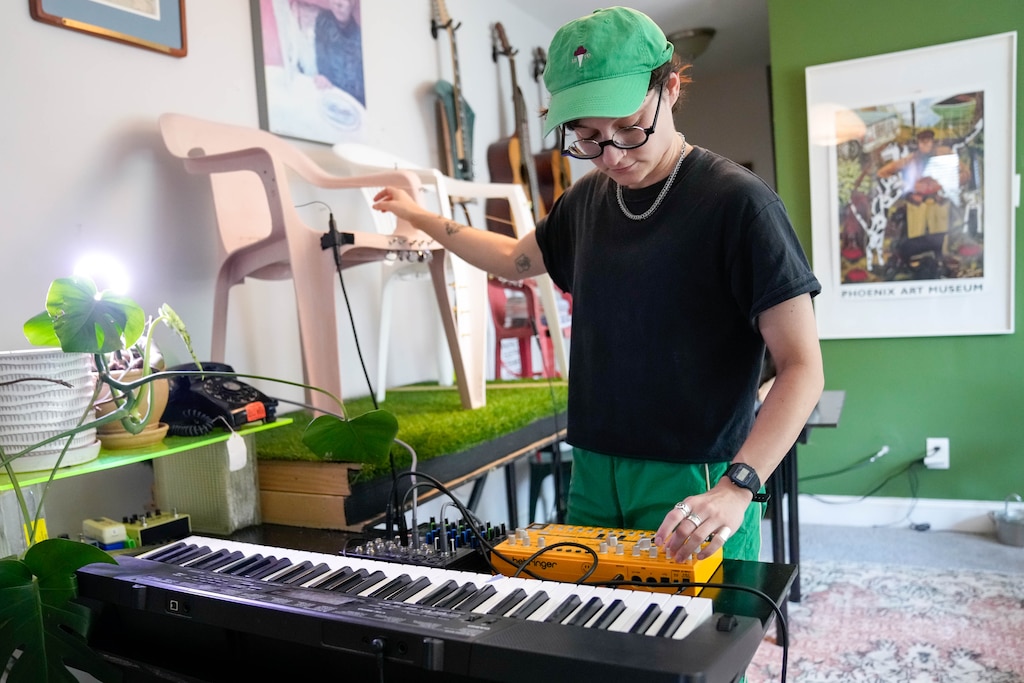 Dan Ortiz Leizman, an artist and lecturer at the University of Maryland, College Park, performs with a synthesizer and a set of Monobloc Chair Harps they created in their home in Hyattsville, Md. on Wednesday, June 10, 2026.