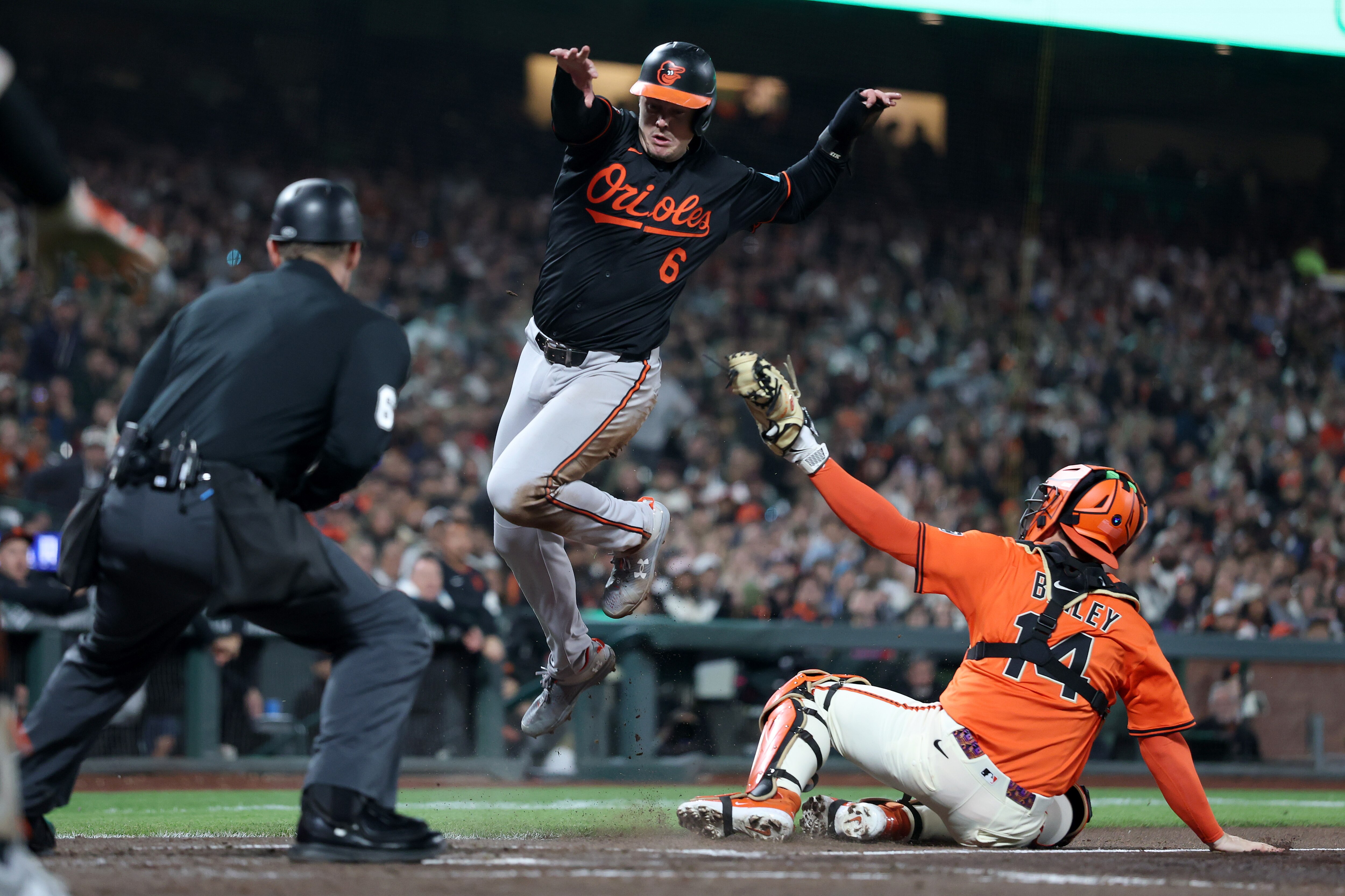 Ryan Mountcastle avoids the tag of Giants catcher Patrick Bailey to score a third-inning run Friday night in San Francisco.