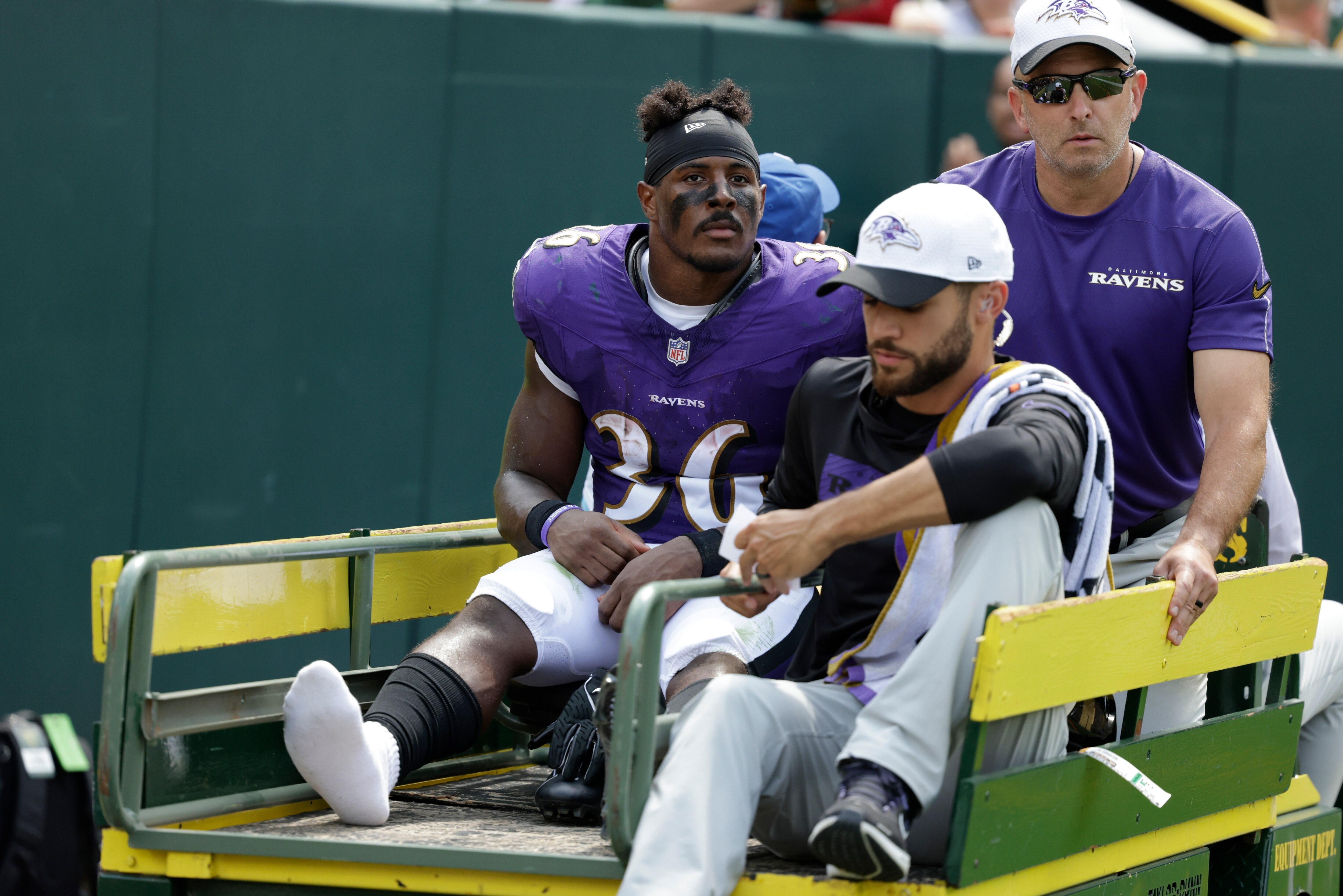 Ravens running back Owen Wright leaves the field after suffering a broken foot Saturday against the Packers.