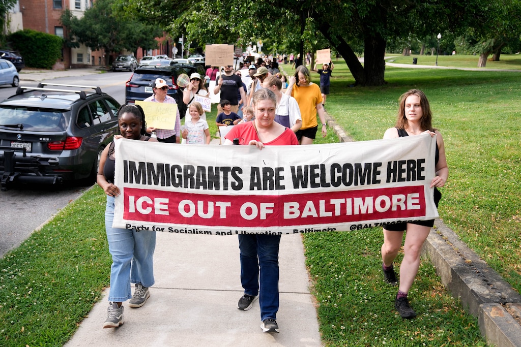 Protesters begin to march around the perimeter of Patterson Park as part of an anti-ICE rally in Baltimore, Md. on Friday, June 12, 2026. The group of community members and parents gathered a day after U.S. Immigration and Customs Enforcement arrested a student’s parents on Commodore John Rodgers Elementary/Middle School’s temporary campus in East Baltimore.