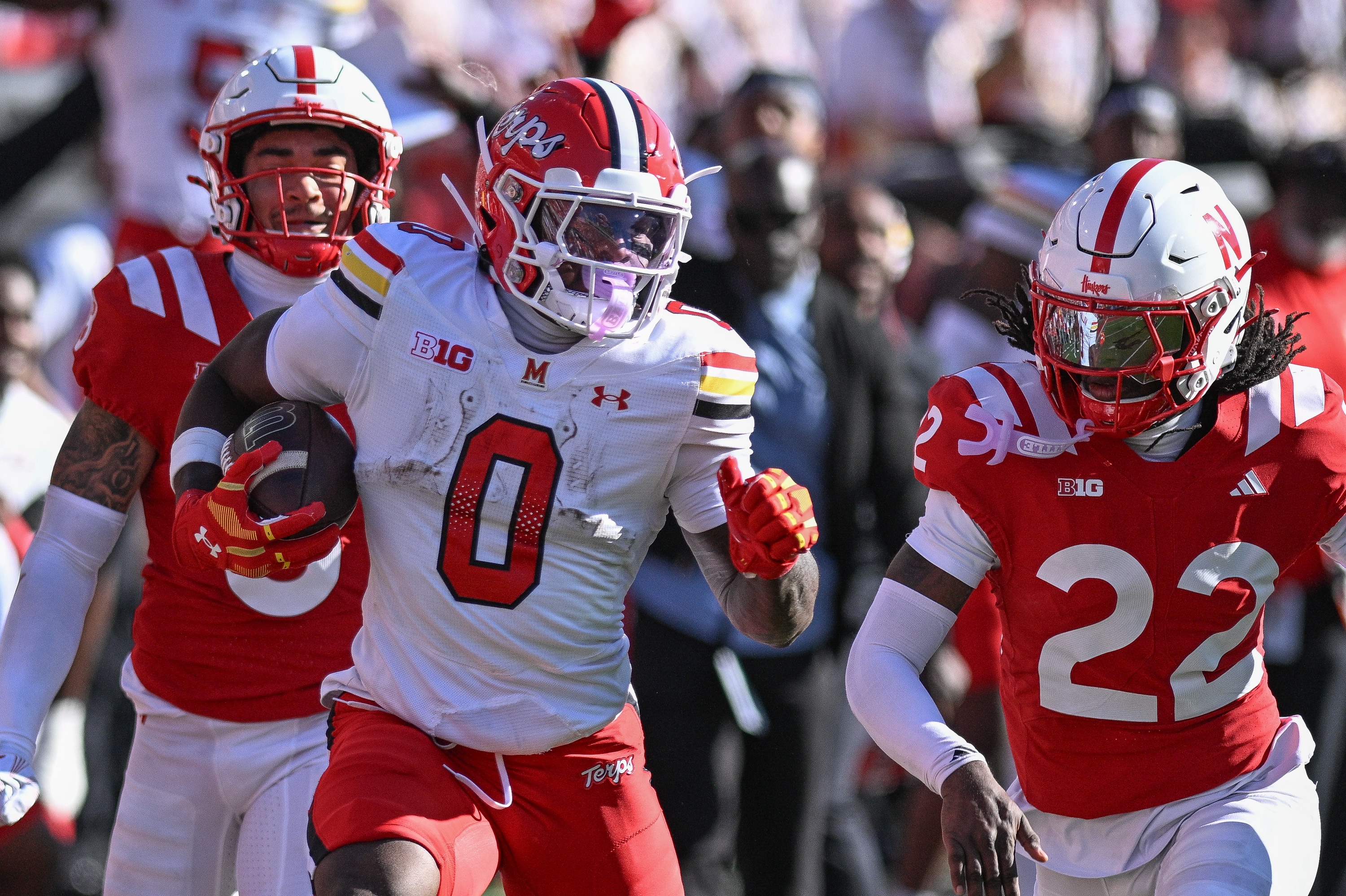 LINCOLN, NEBRASKA - OCTOBER 3: DeJuan Williams #0 of the Maryland Terrapins runs from Victor Evans III #22 of the Nebraska Cornhuskers and Donovan Jones #8 during the first half at Memorial Stadium on October 3, 2026 in Lincoln, Nebraska.  (Photo by Steven Branscombe/Getty Images)