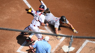 Pittsburgh Pirates' Konnor Griffin, right, steals home to score against Washington Nationals catcher Drew Millas, left, during the first inning.