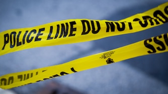 Baltimore Police crime scene tape remains on the scene after a vehicle exploded inside a five-story parking garage in Baltimore’s Fells Point neighborhood on 7/27/22. Two people are being treated for injuries, fire officials said Wednesday afternoon.