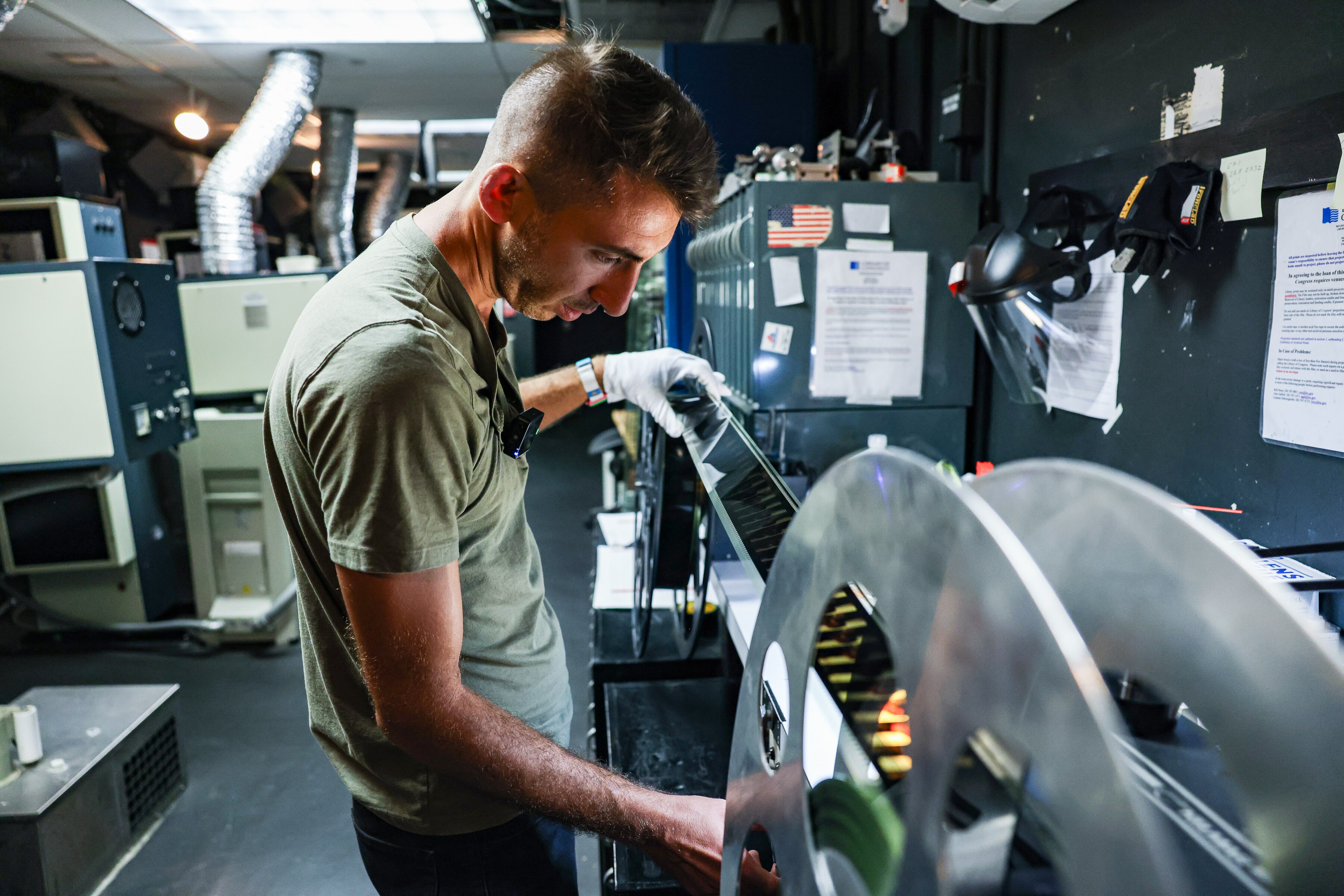 Projectionist Andrew Tamburrino inspects the new movie “One Battle After Another” in 70mm at the AFI Silver Theatre and Cultural Center in Silver Spring.