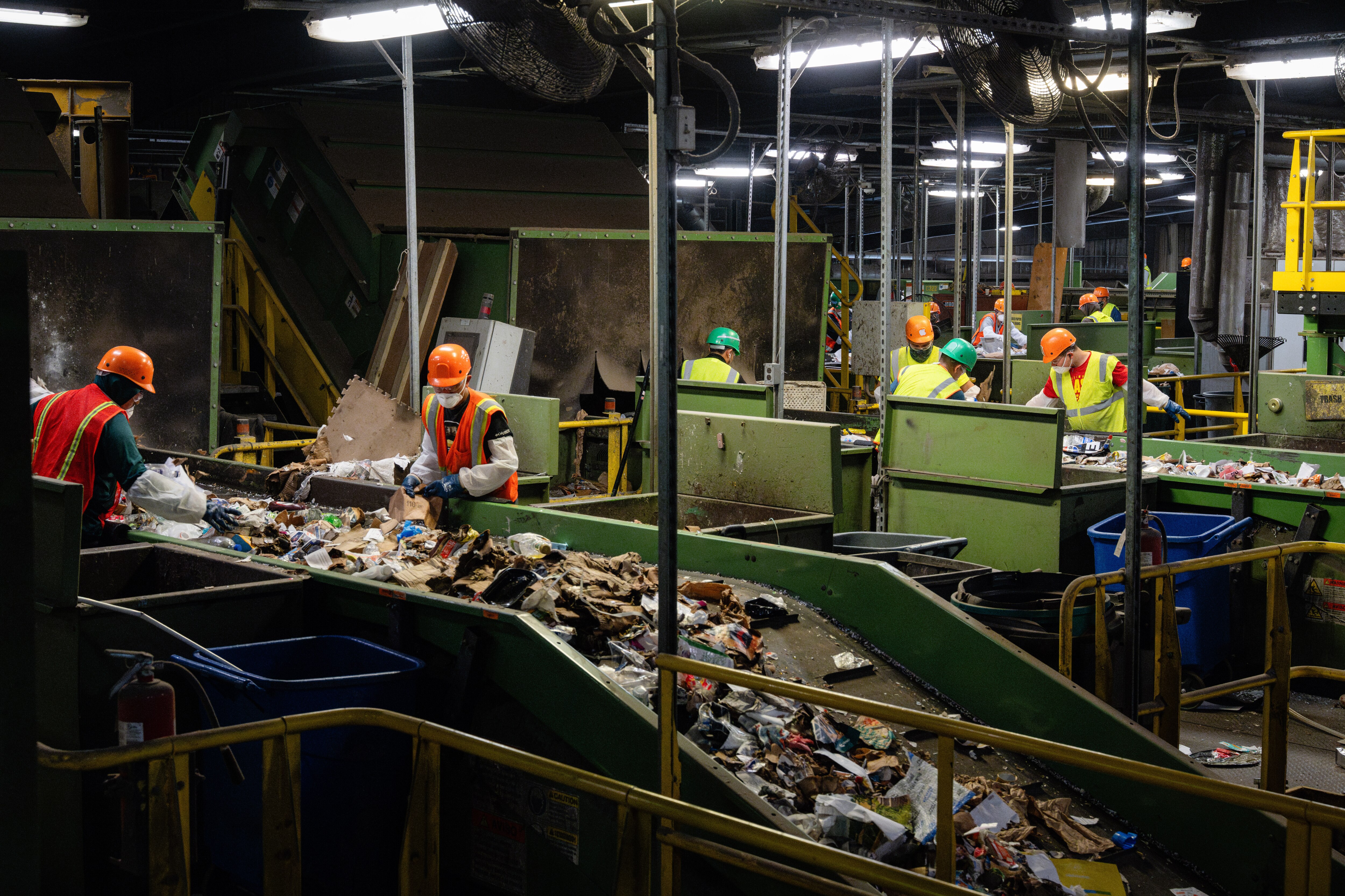 Workers sort through multiple sets of conveyor belts of recycled materials within the Materials Recovery Facility at the Baltimore County Central Acceptance Facility, as seen during a tour of the facility on May 23rd, 2025 in Cockeysville, MD.