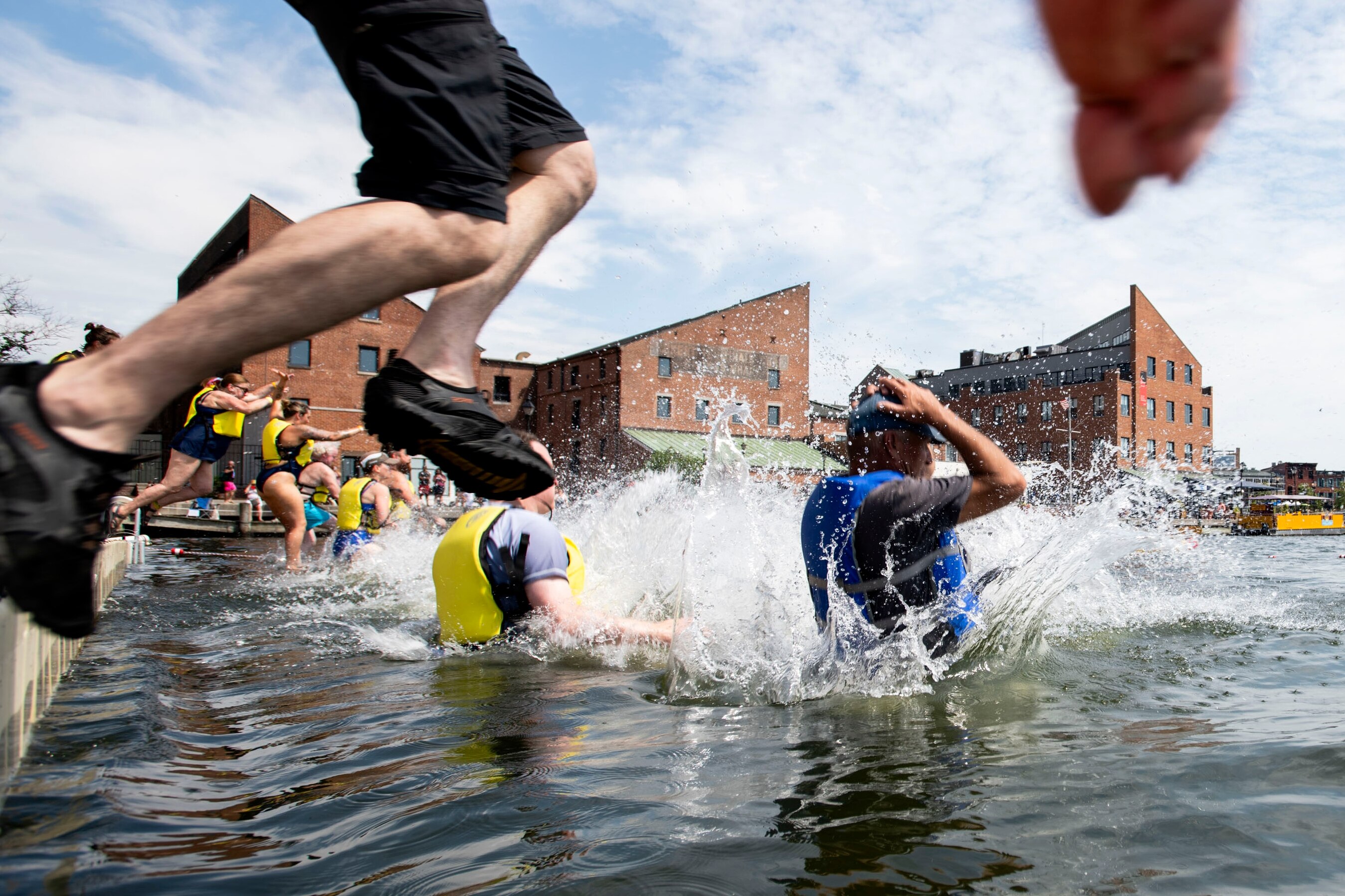 Harbor jumpers leap into the waters of Fells Point during the Harbor Splash 2024 event on 6/23/24 in Baltimore, MD.