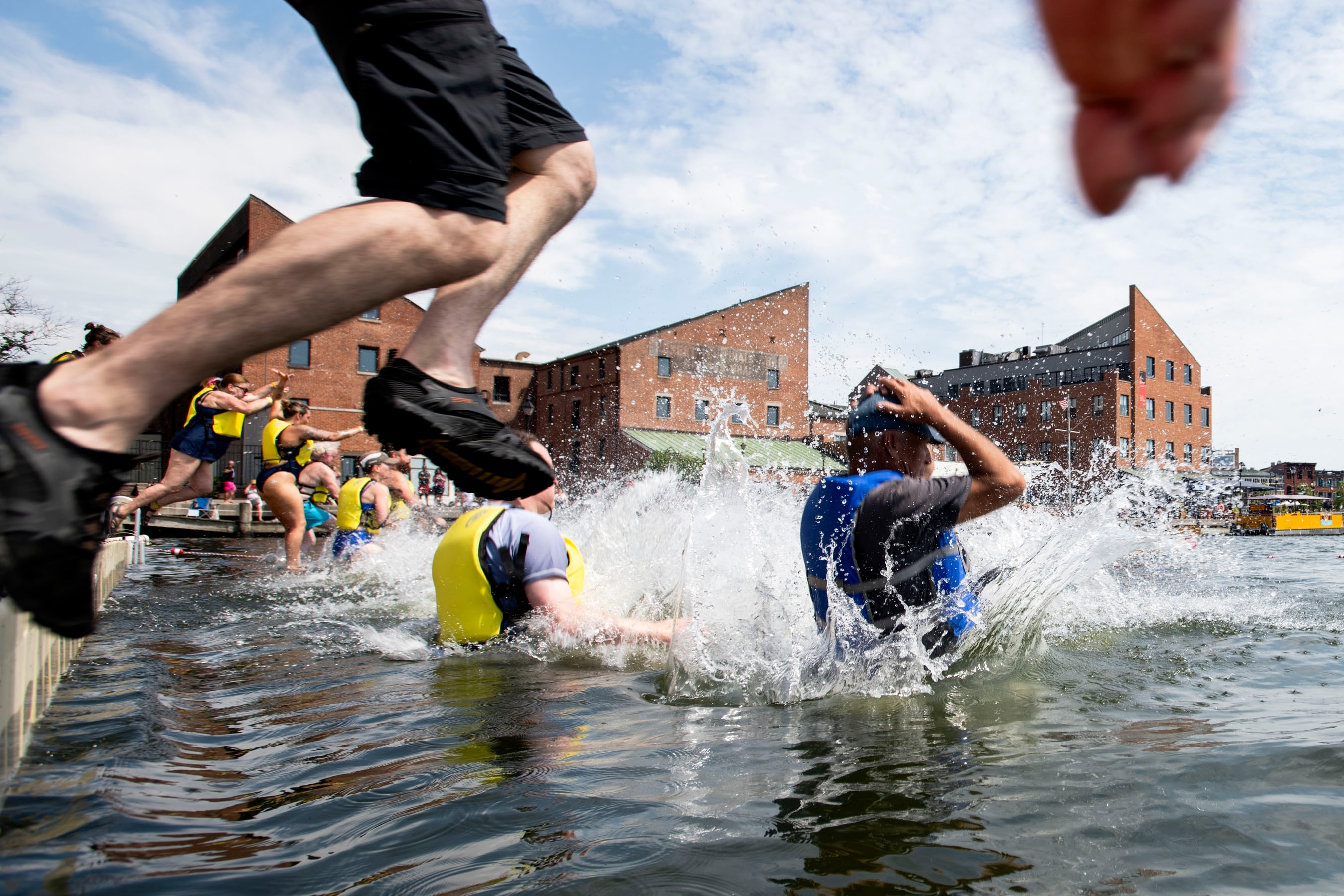 Harbor jumpers leap into the waters of Fells Point during the Harbor Splash 2024 event on 6/23/24 in Baltimore, MD.