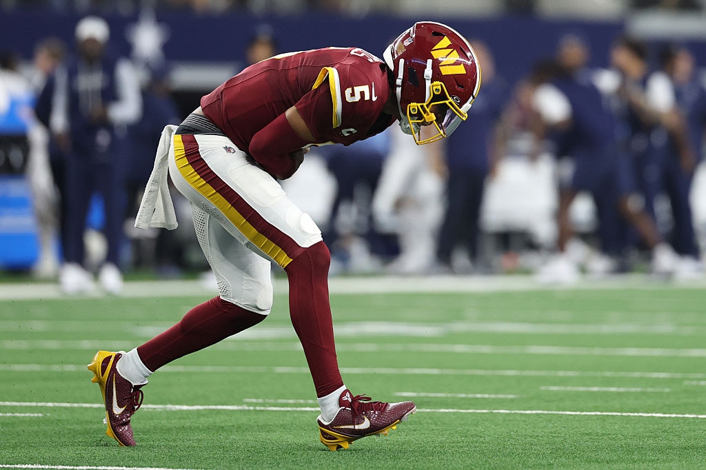 Washington Commanders quarterback Jayden Daniels reacts after sustaining an elbow injury against the Dallas Cowboys in the second quarter.