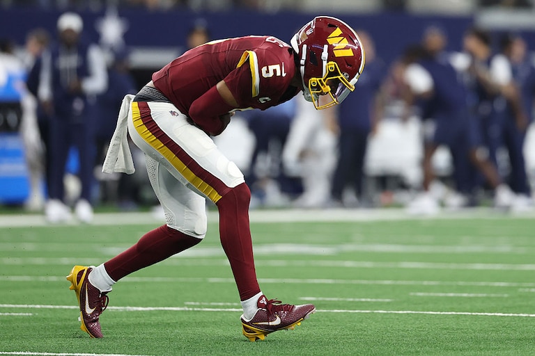 Washington Commanders quarterback Jayden Daniels reacts after sustaining an elbow injury against the Dallas Cowboys in the second quarter.