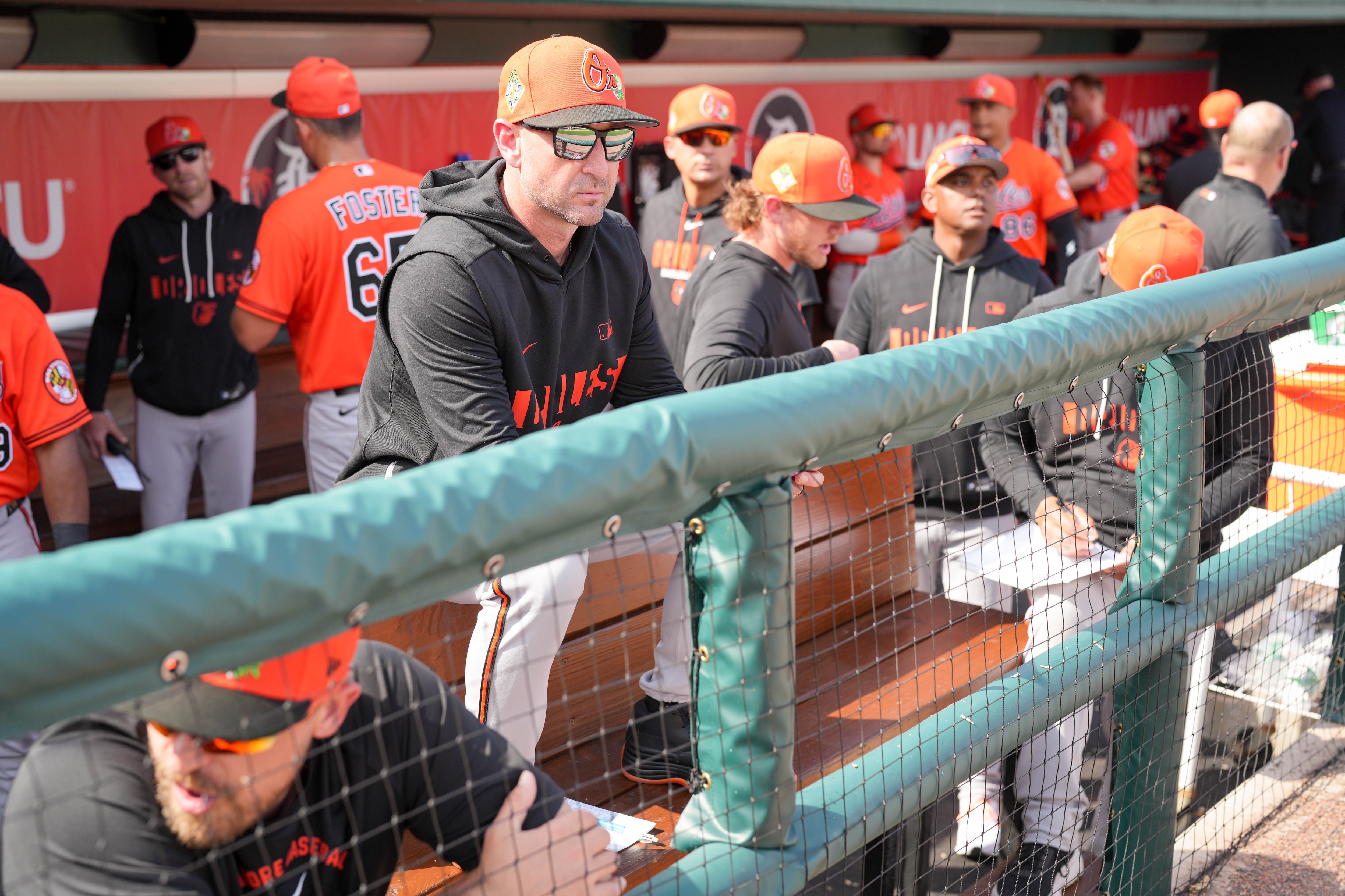 Orioles manager Craig Albernaz, center, watches from the dugout during the fifth inning of a spring training game against the Detroit Tigers on Feb. 22.