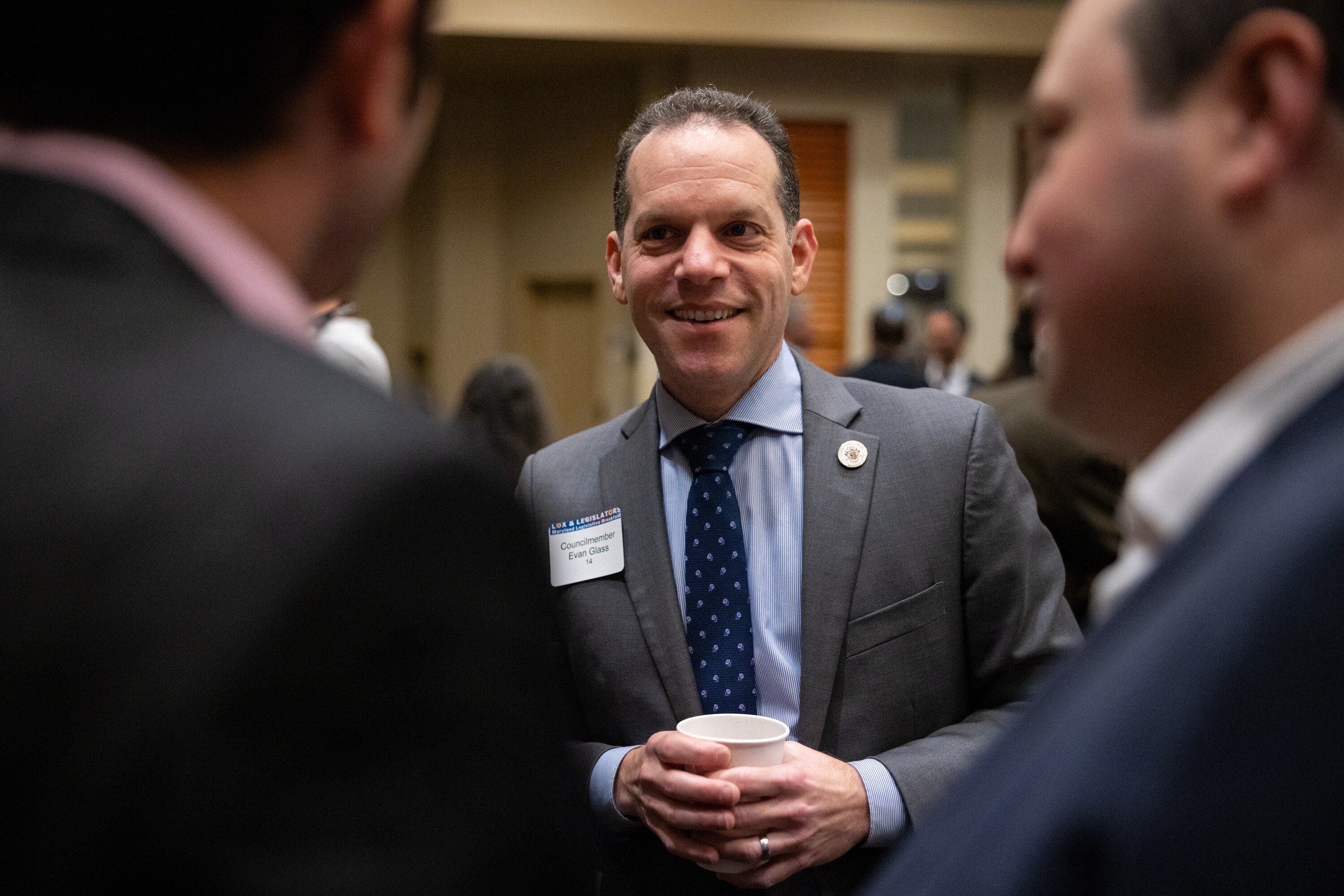 Council member Evan Glass greets attendees at the annual JCRC Legislators and Lox breakfast last year.