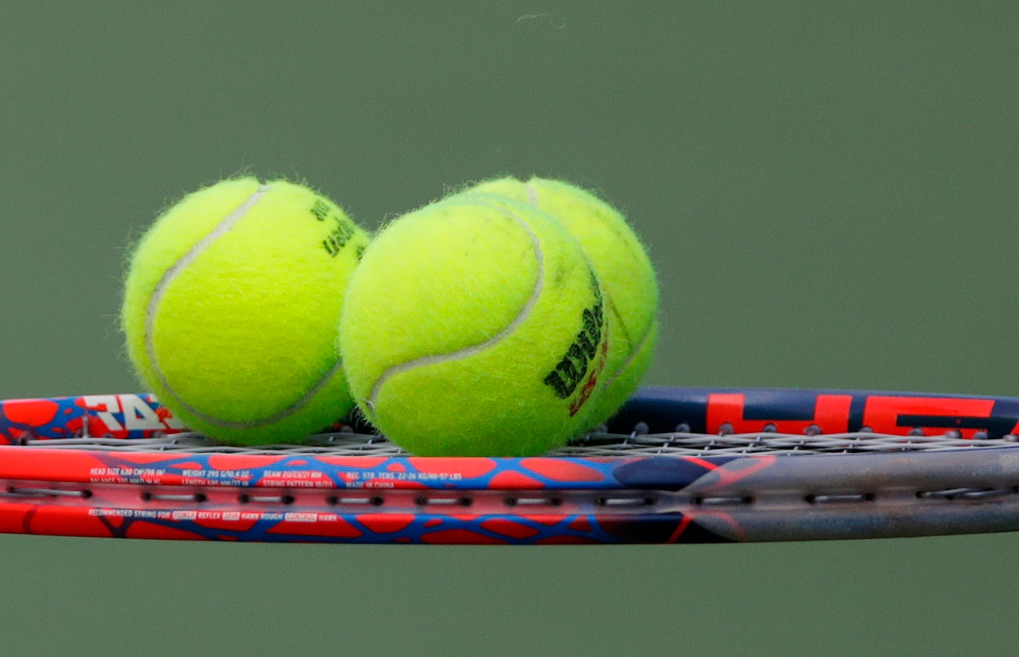 Tennis balls sit on the racket of Diego Schwartzman, of Argentina, during a match against Jaume Munar, of Spain, during the second round of the U.S. Open tennis tournament, Thursday, Aug. 30, 2018, in New York.