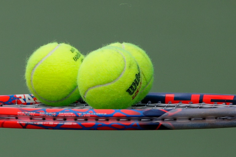 Tennis balls sit on the racket of Diego Schwartzman, of Argentina, during a match against Jaume Munar, of Spain, during the second round of the U.S. Open tennis tournament, Thursday, Aug. 30, 2018, in New York.