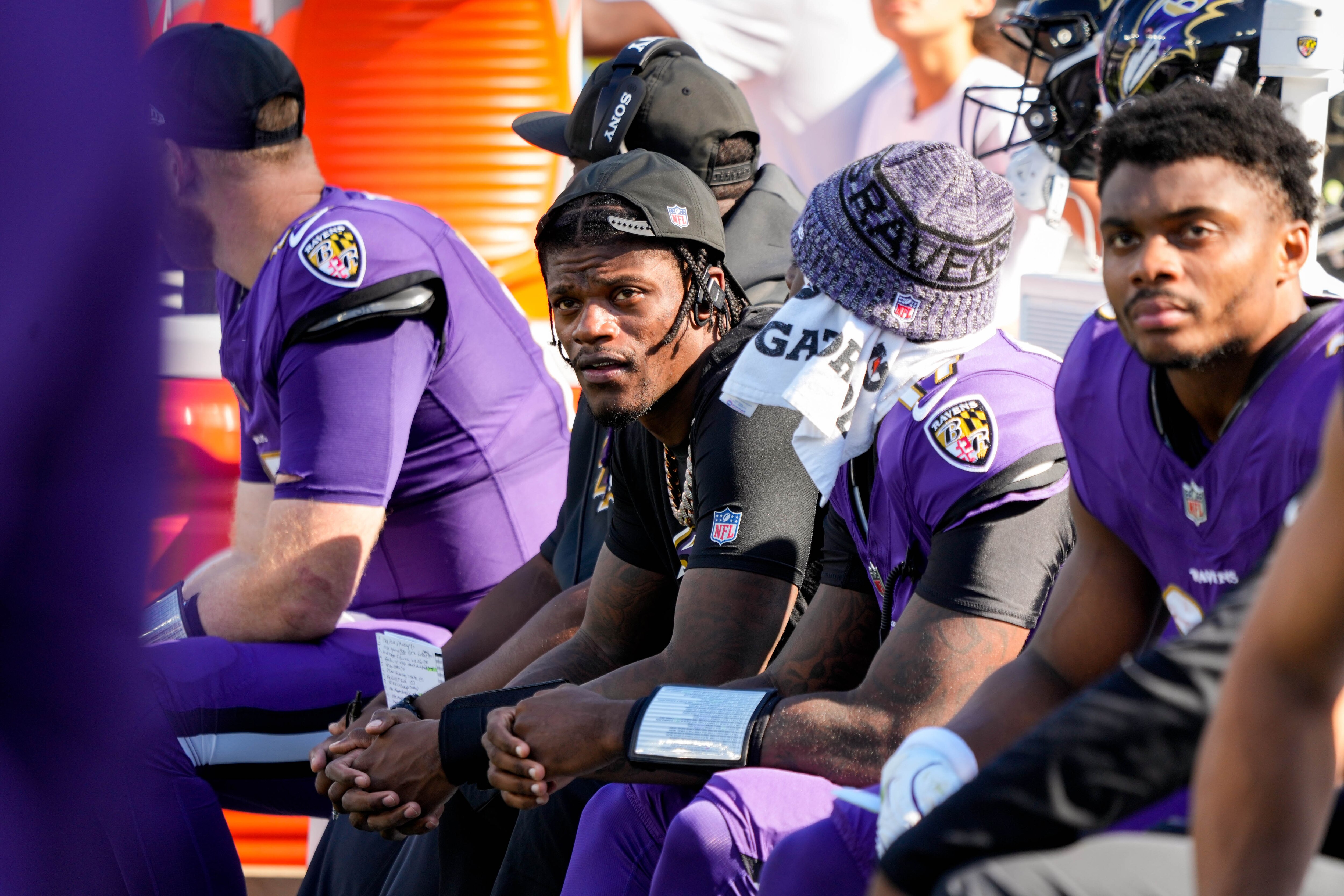 Baltimore Ravens quarterback Lamar Jackson (8) sits with teammates in the fourth quarter of a game at M&T Bank Stadium in Baltimore, Md., on Sunday, Oct. 5, 2025.