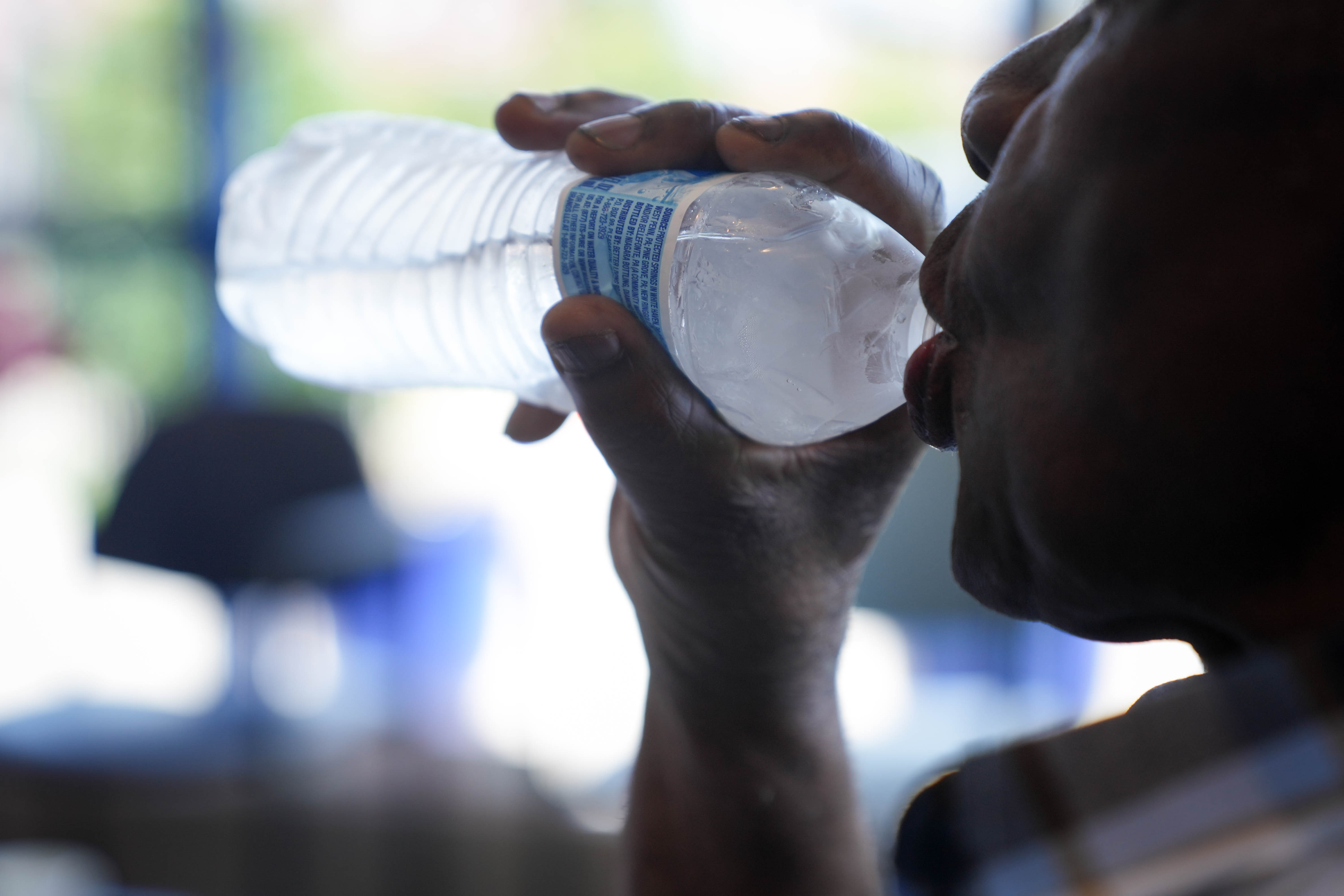 Ben Jones sips a bottle of water inside the Zeta Center for Healthy and Active Aging, one of the Baltimore City Health Department’s cooling centers, in northwest Baltimore, Md. on Monday, June 23, 2025.