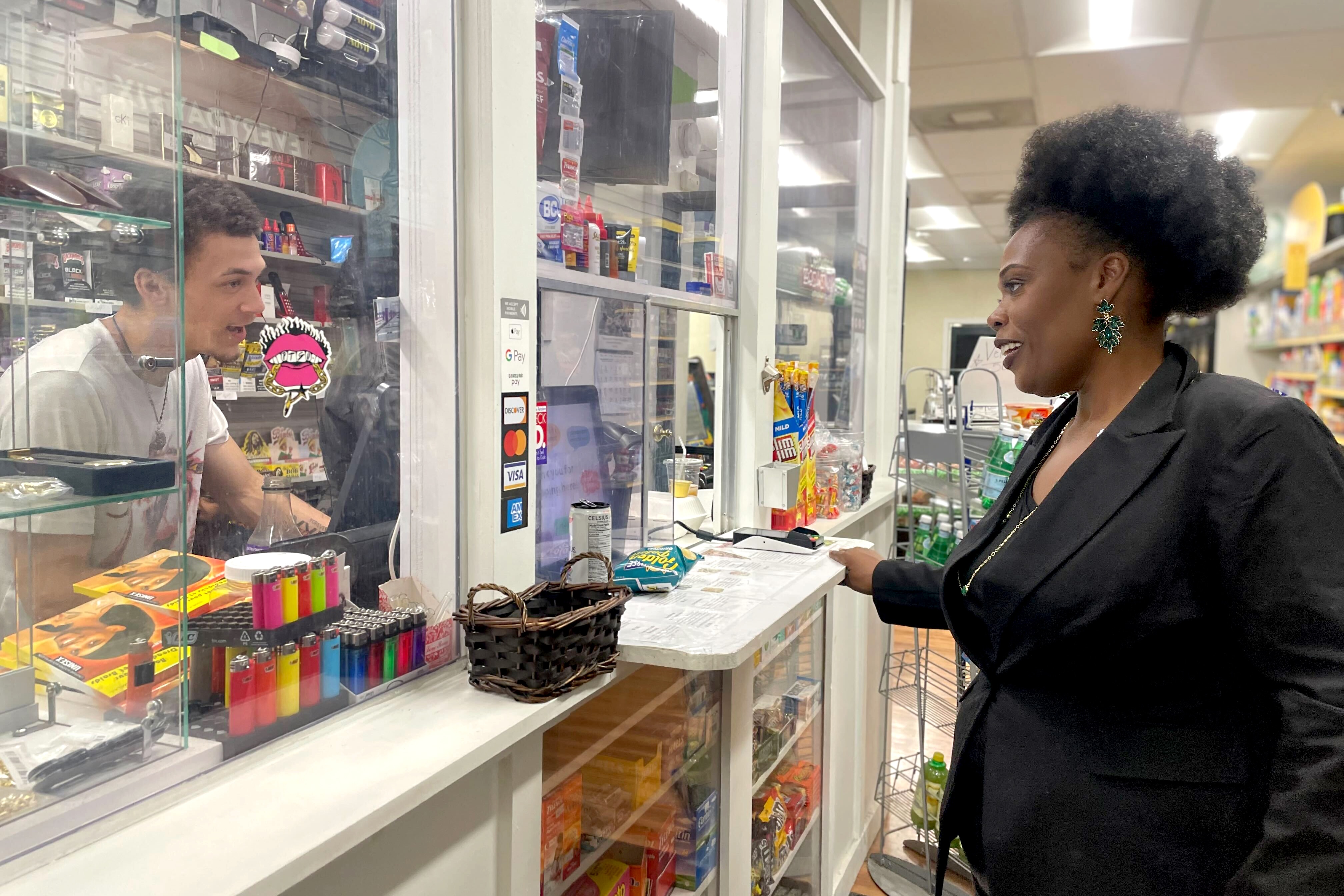 Ernestine Chambers chats with her son, who is behind the counter of Chopped, a new bodega in Fells Point.