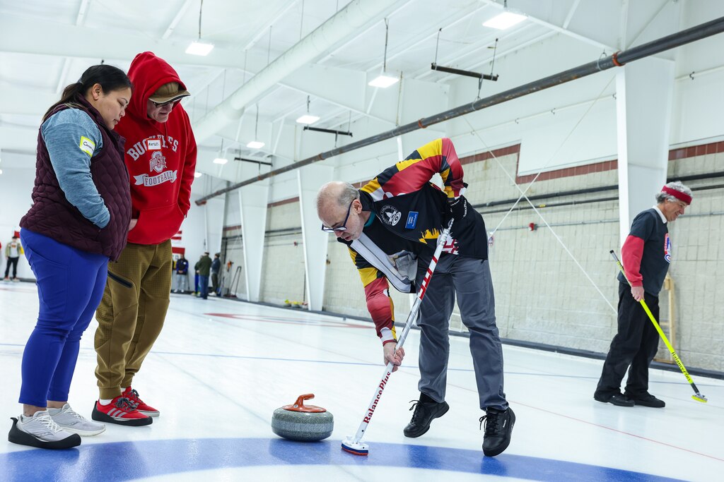 SATURDAY, FEBRUARY 21Β - A member of the Potomac Curling Club instructs first-time curlers how to sweep during an open house at the club in Laurel, Md. Interest in the sport has grown following the recent 2026 Winter Olympics in Cortina, Italy, drawing new participants to the Maryland club.