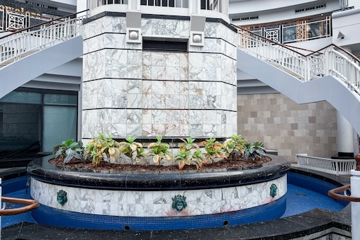 The Towson Town Center mall is showing signs of wear and inattentive management. The fountain, which used to run, is now off. Children used to enjoy throwing pennies in it. Water damage is evident on the ceiling, and the skylights are dirty.