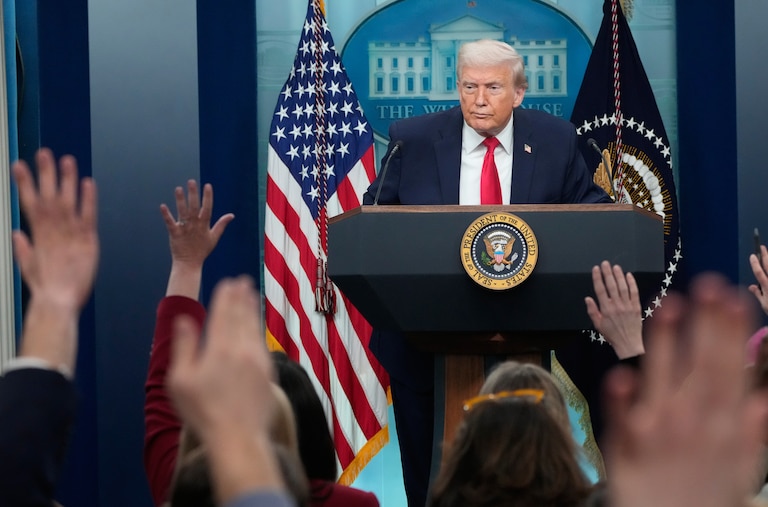 Reporters raise their hands as President Donald Trump speaks during a press briefing at the White House in Washington, Tuesday, Jan. 20, 2026.