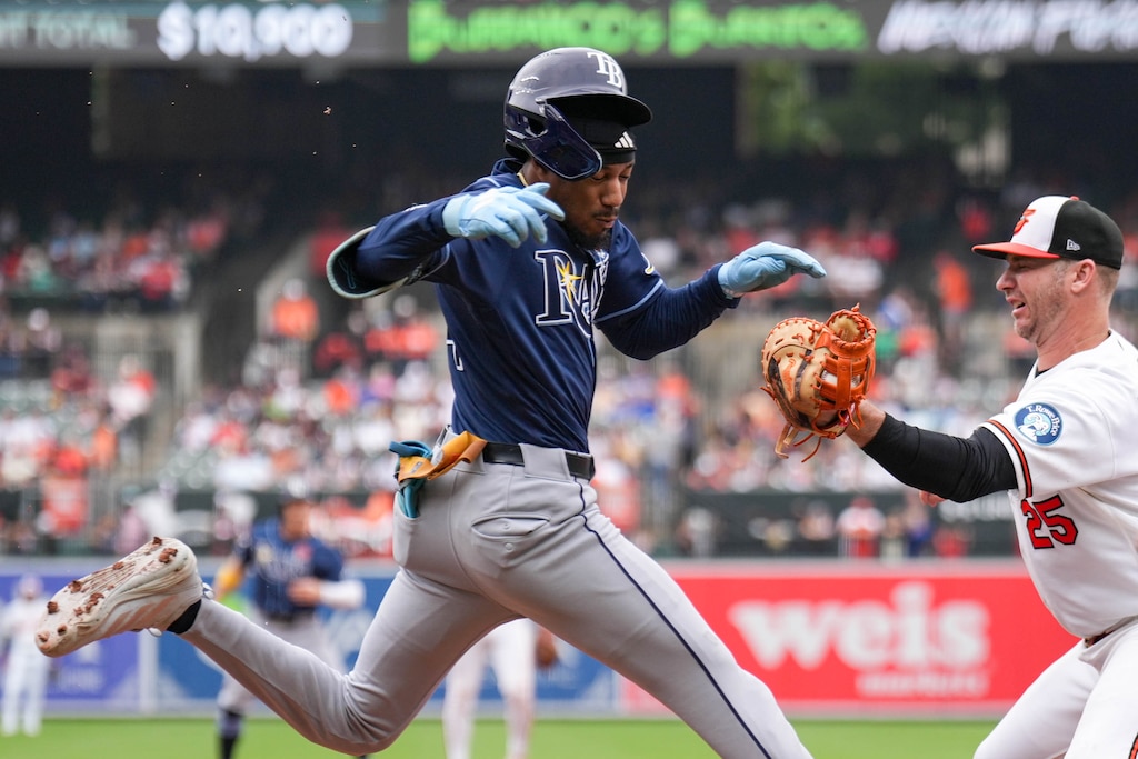 Tampa Bay Rays left fielder Chandler Simpson (14) is tagged out at first base by Baltimore Orioles first baseman Pete Alonso (25) in the fifth inning of a baseball game at Oriole Park at Camden Yards in Baltimore, Md. on Monday, May 25, 2026.