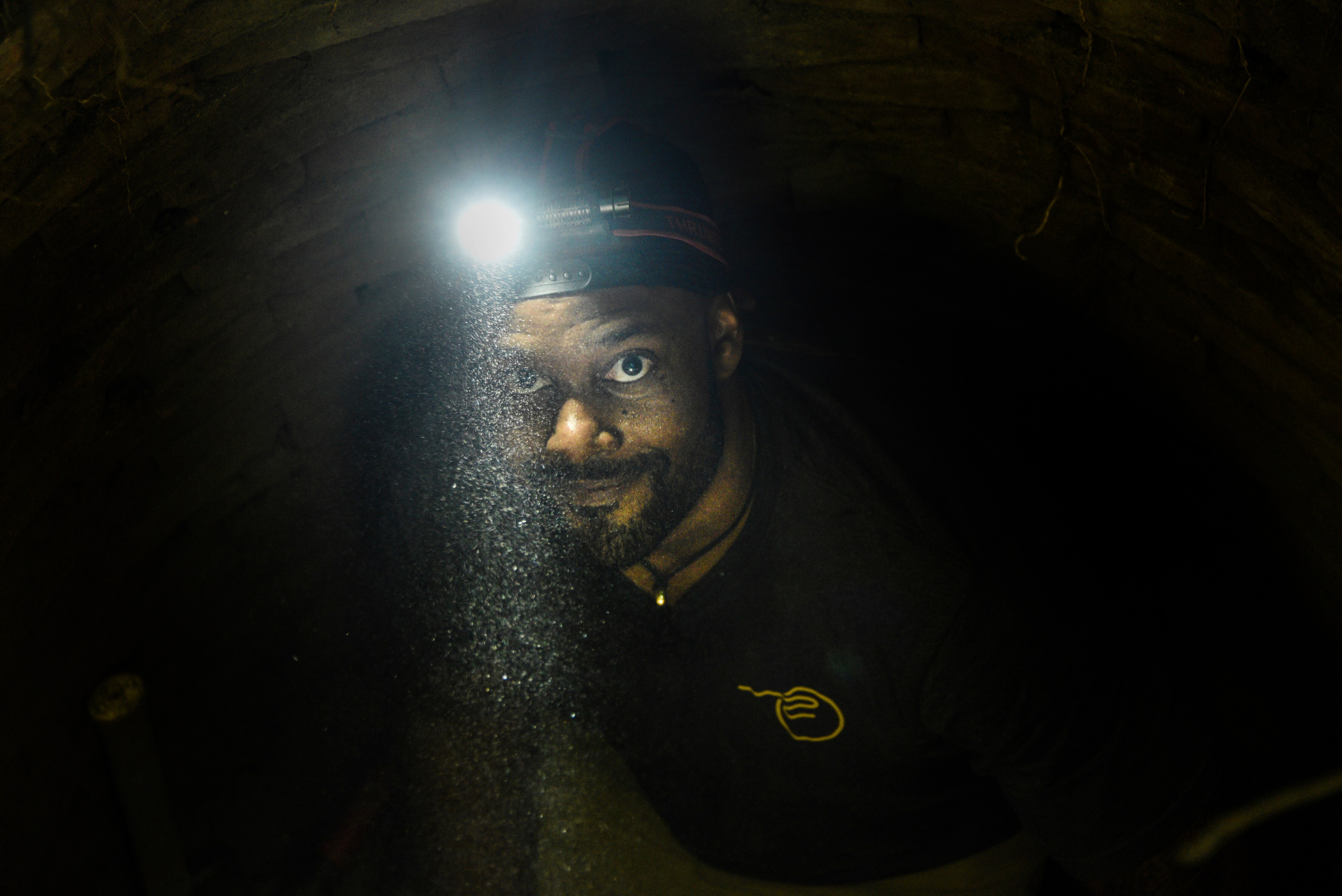 Evan Woodard, founder of Salvage Arc, searches for treasures of Baltimore's past at the Orchard Street privy.