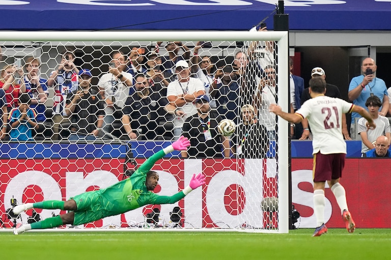 Spain's Mikel Oyarzabal scores the opening goal from the penalty spot past France goalkeeper Mike Maignan during the World Cup semifinal soccer match.