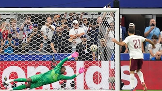 Spain's Mikel Oyarzabal scores the opening goal from the penalty spot past France goalkeeper Mike Maignan during the World Cup semifinal soccer match.