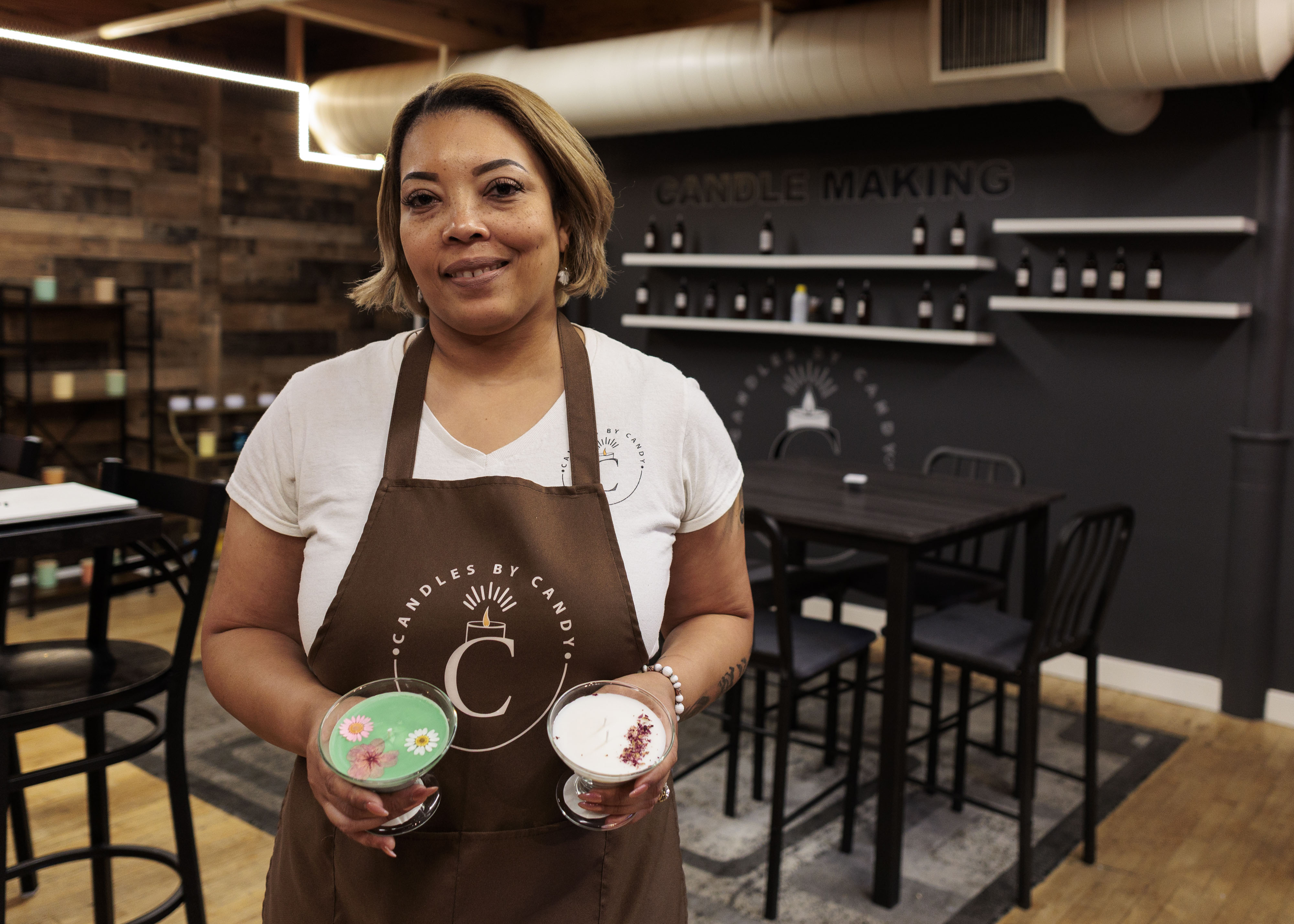 Candace “Candy” Bell stands in her store, Candles by Candy, inside Savage Mill, where she sells handcrafted candles, goods from other artisans, and hosts candlemaking workshops. 