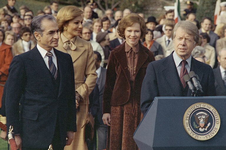President Jimmy Carter and the Shah of Iran, Empress Farah and Mrs. Roslynn Carter during the South Lawn ceremony in Washington on Nov. 15, 1977. (AP Photo)