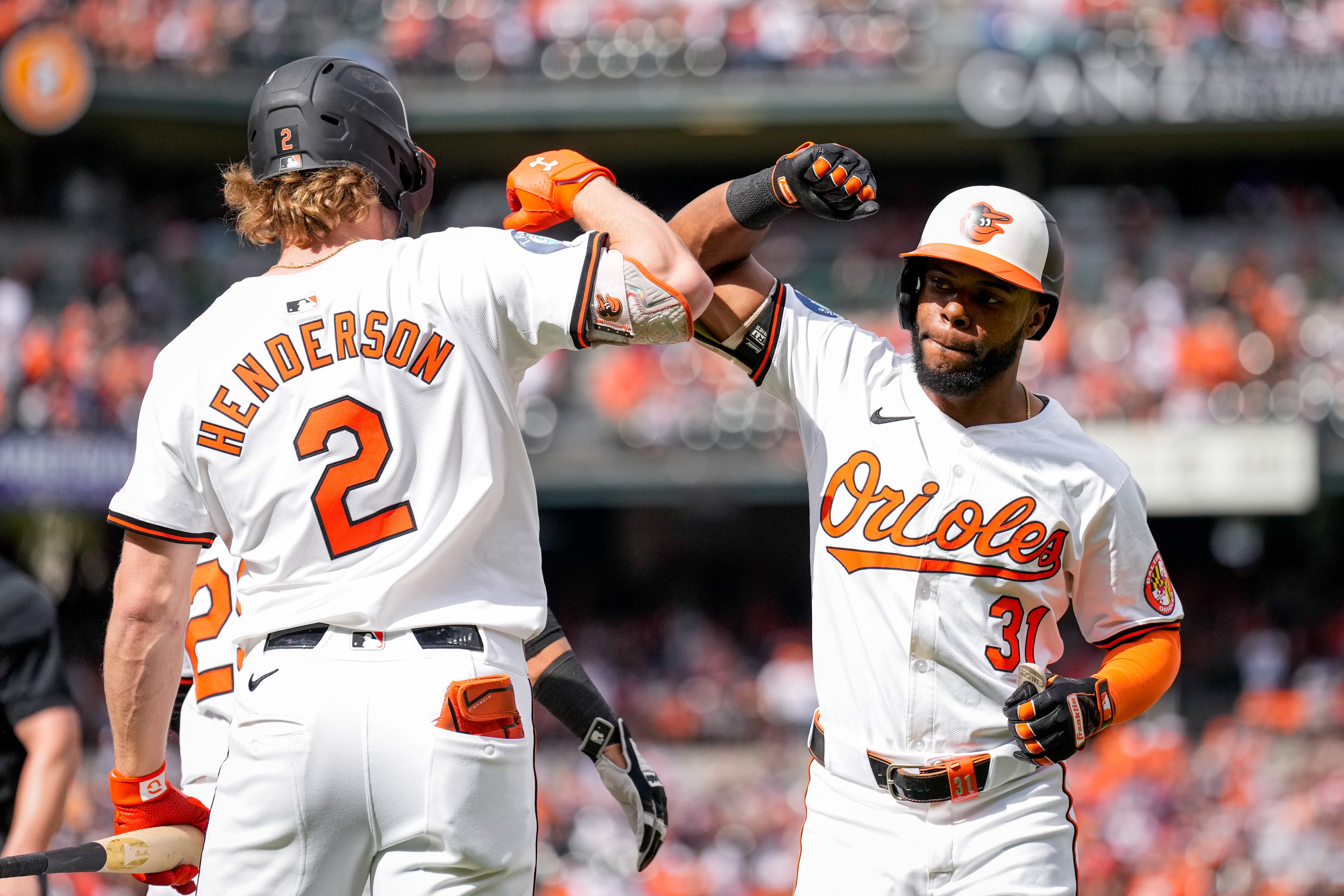Orioles outfielder Cedric Mullins receives congratulations from shortstop Gunnar Henderson after a home run Sunday at Camden Yards.