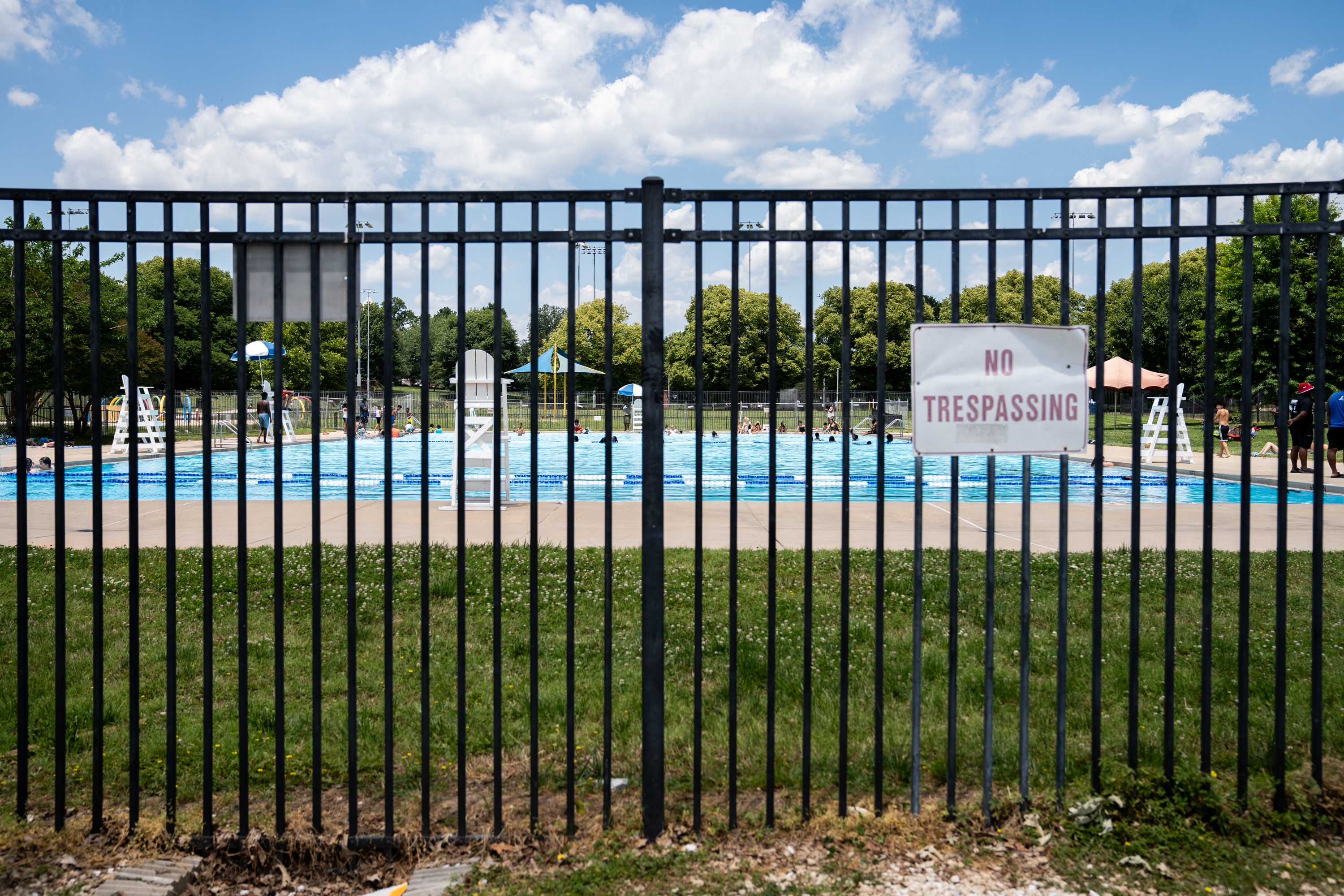 People swim at the Patterson Park pool on Sunday after it was suddenly closed due to vandalism the night before that left the facility’s pool damaged. 
