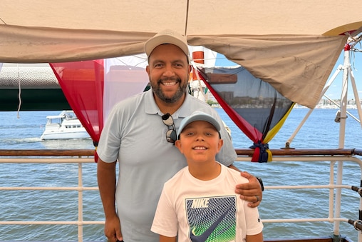 Erick Guillermo stands aboard the Spanish ship with his son.