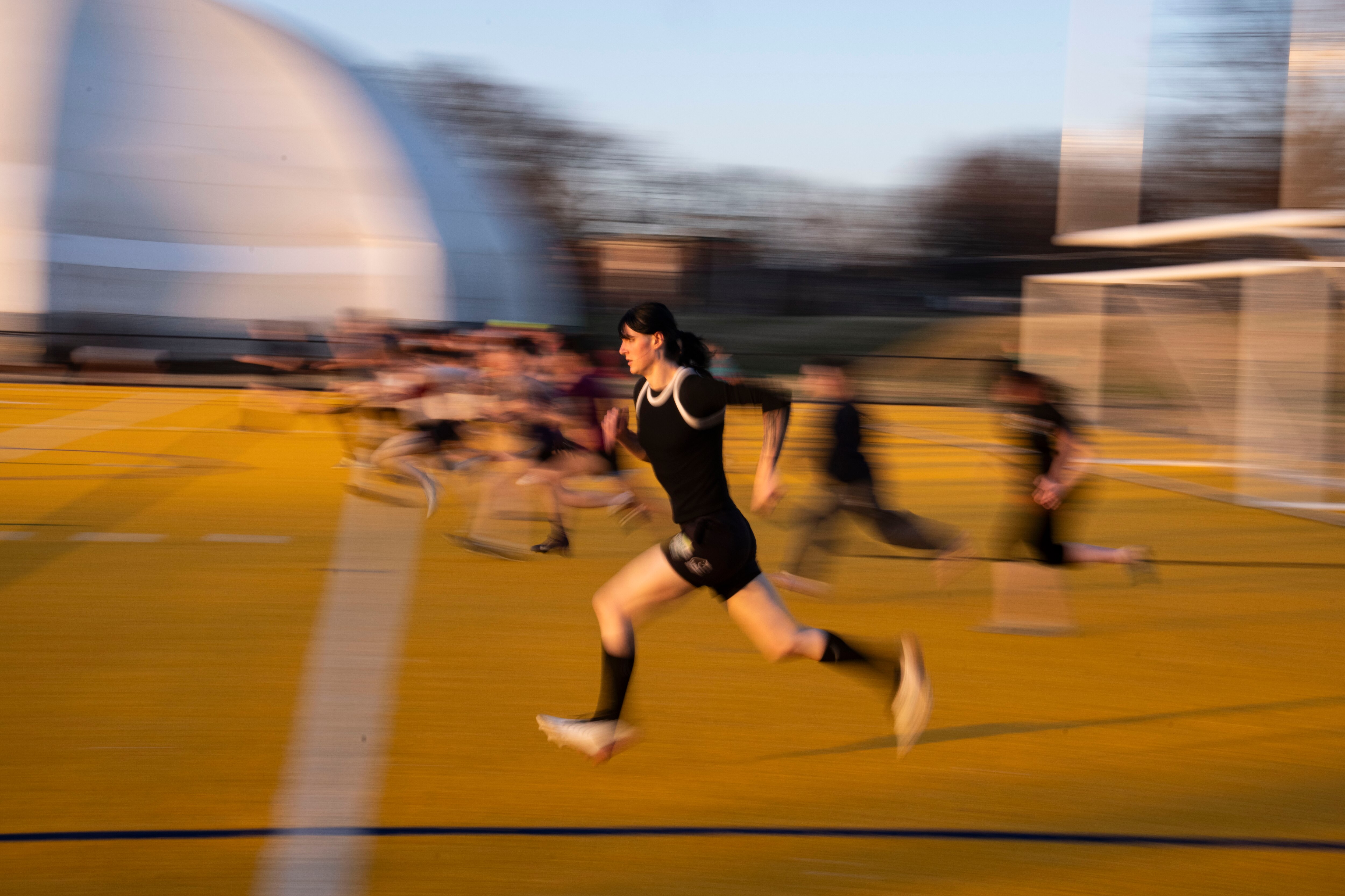 Harper Ockert runs drills with teammates at Utz Field in Patterson Park during Ferals rugby practice, in Baltimore, Tuesday March 10, 2026.