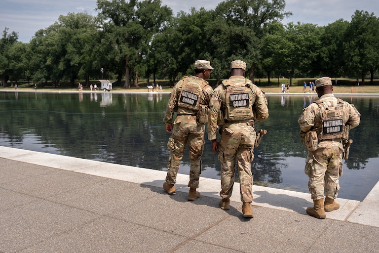 National Guard members look at the Lincoln Memorial Reflecting Pool, Monday, June 22, 2026, in Washington.