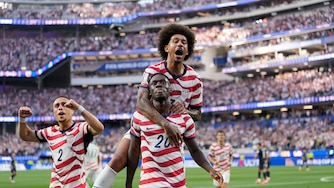 United States' Folarin Balogun (20) celebrates scoring his side's third goal against Paraguay with teamates during the World Cup Group D soccer match in Inglewood, Calif., near Los Angeles, Friday, June 12, 2026. (AP Photo/Andre Penner)