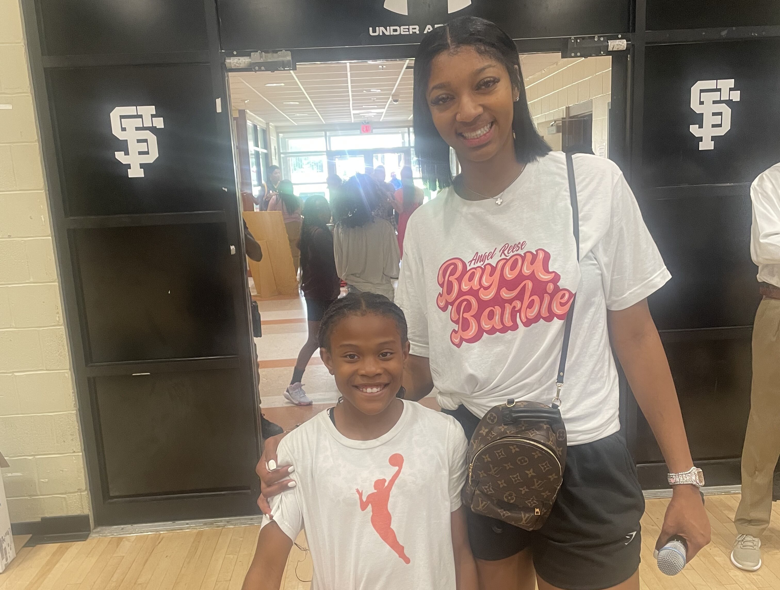 Aubree Singletary, left, met her idol Angel Reese at a Baltimore basketball camp.