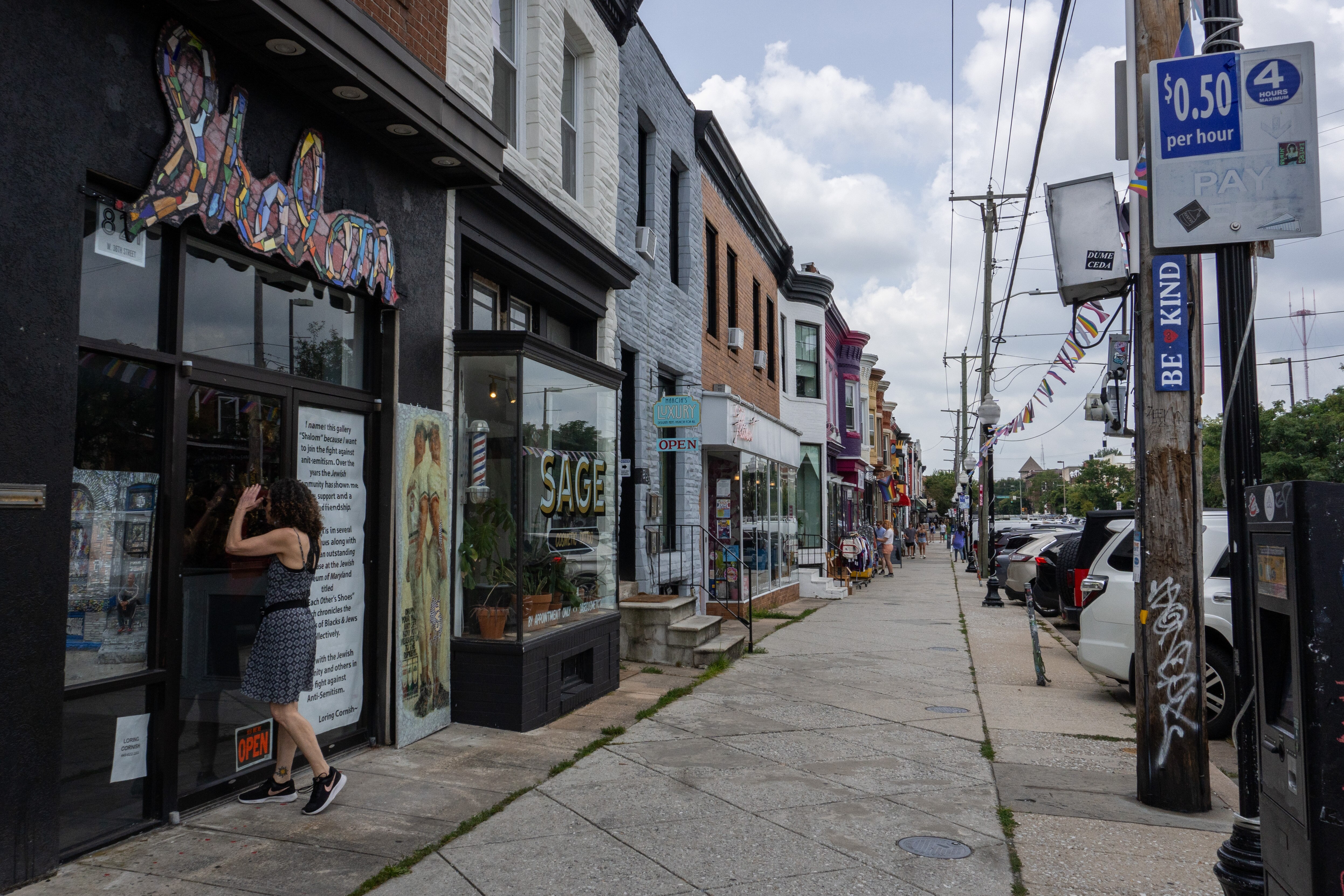 A woman peers through the door of Shalom Art Gallery.