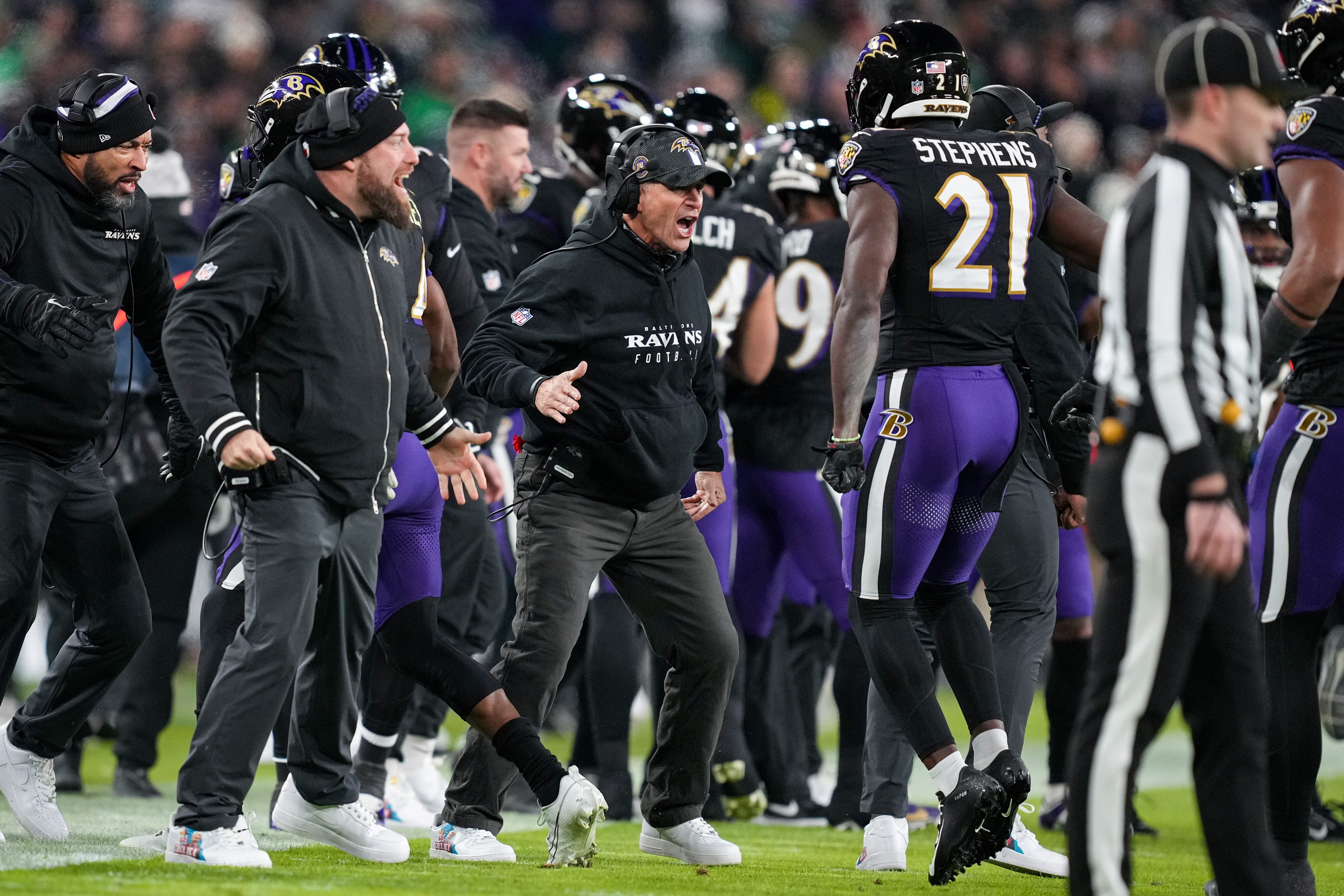 Baltimore Ravens head coach John Harbaugh celebrates with his defense after they sacked Philadelphia Eagles quarterback Jalen Hurts.