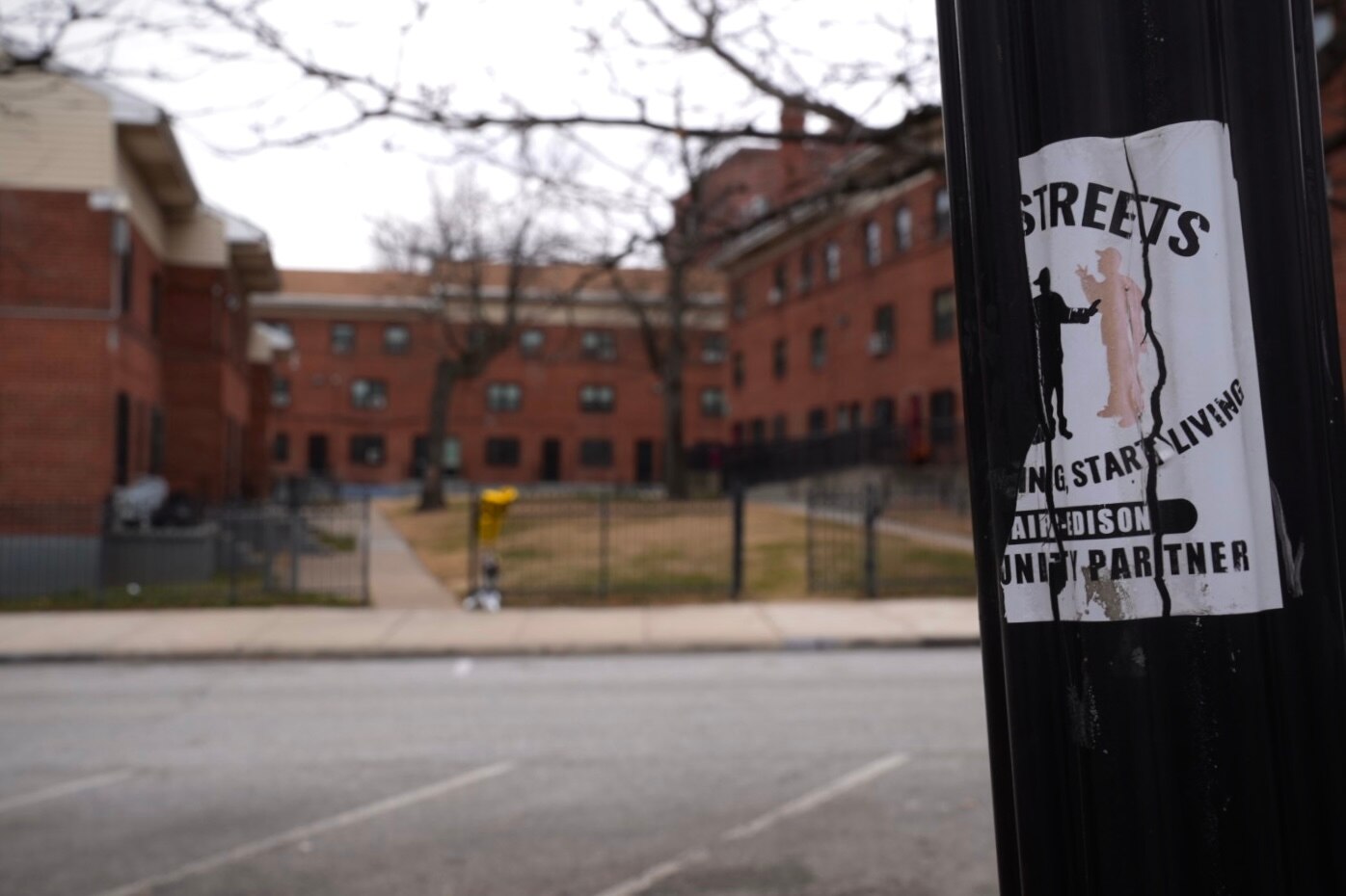 A Safe Streets sticker on a lamp post outside of the Douglass Homes.