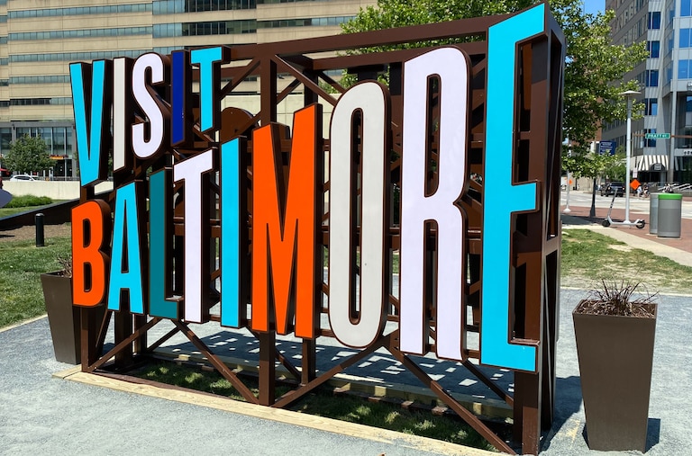 A view of the "Visit Baltimore" sign by Inner Harbor.