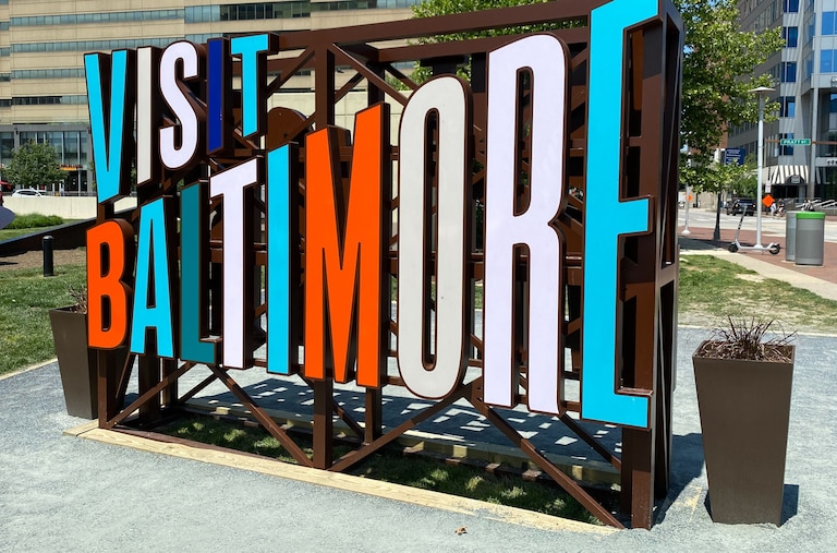 A view of the "Visit Baltimore" sign by Inner Harbor.