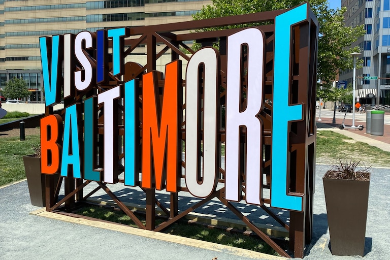 A view of the "Visit Baltimore" sign by Inner Harbor.
