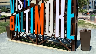 A view of the "Visit Baltimore" sign by Inner Harbor.