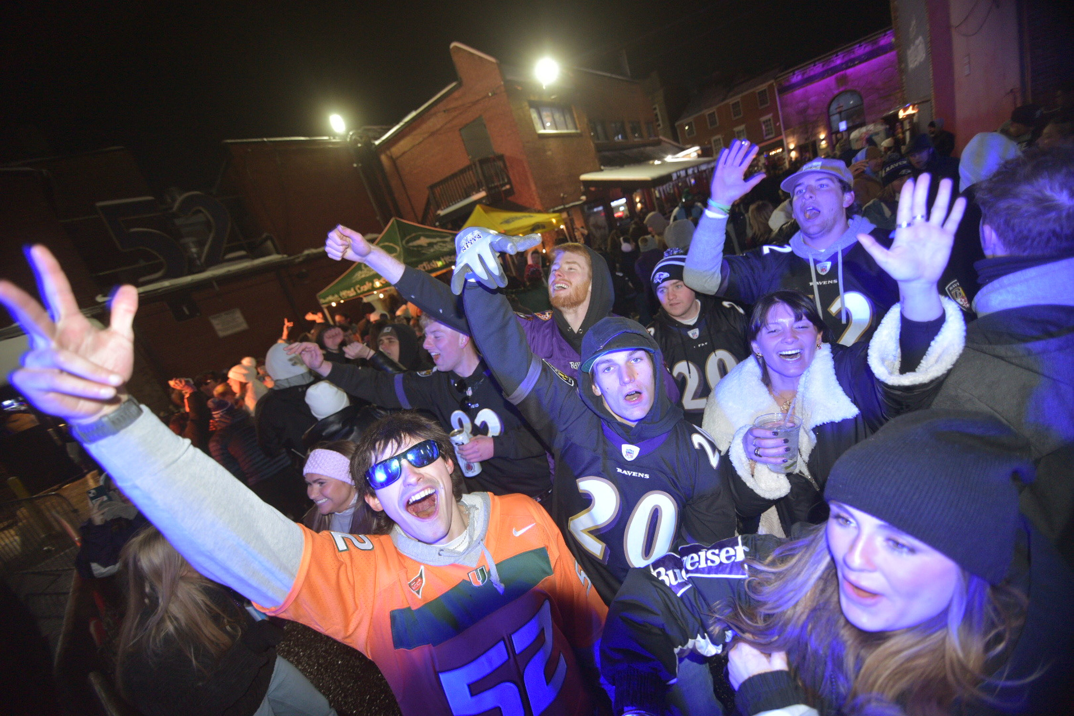 Ravens fans at Mother’s Purple Patio celebrate the team's second touchdown during the AFC divisional playoff game Saturday.