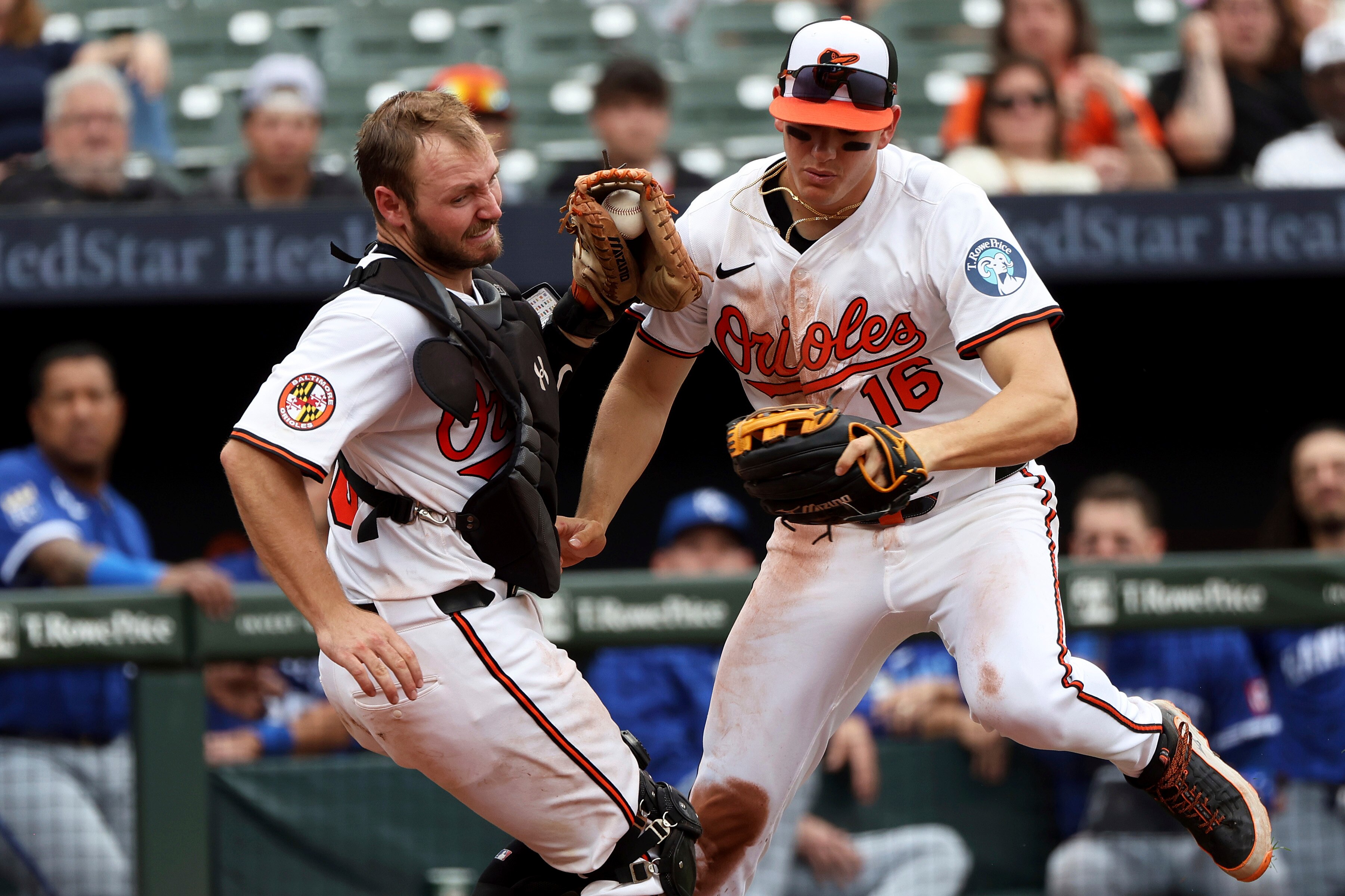 Baltimore Orioles catcher Maverick Handley, left, catches the ball for an out in foul territory as third baseman Coby Mayo, right, nearly collides with him during the seventh inning of a baseball game against the Kansas City Royals, Sunday, May 4, 2025, in Baltimore.